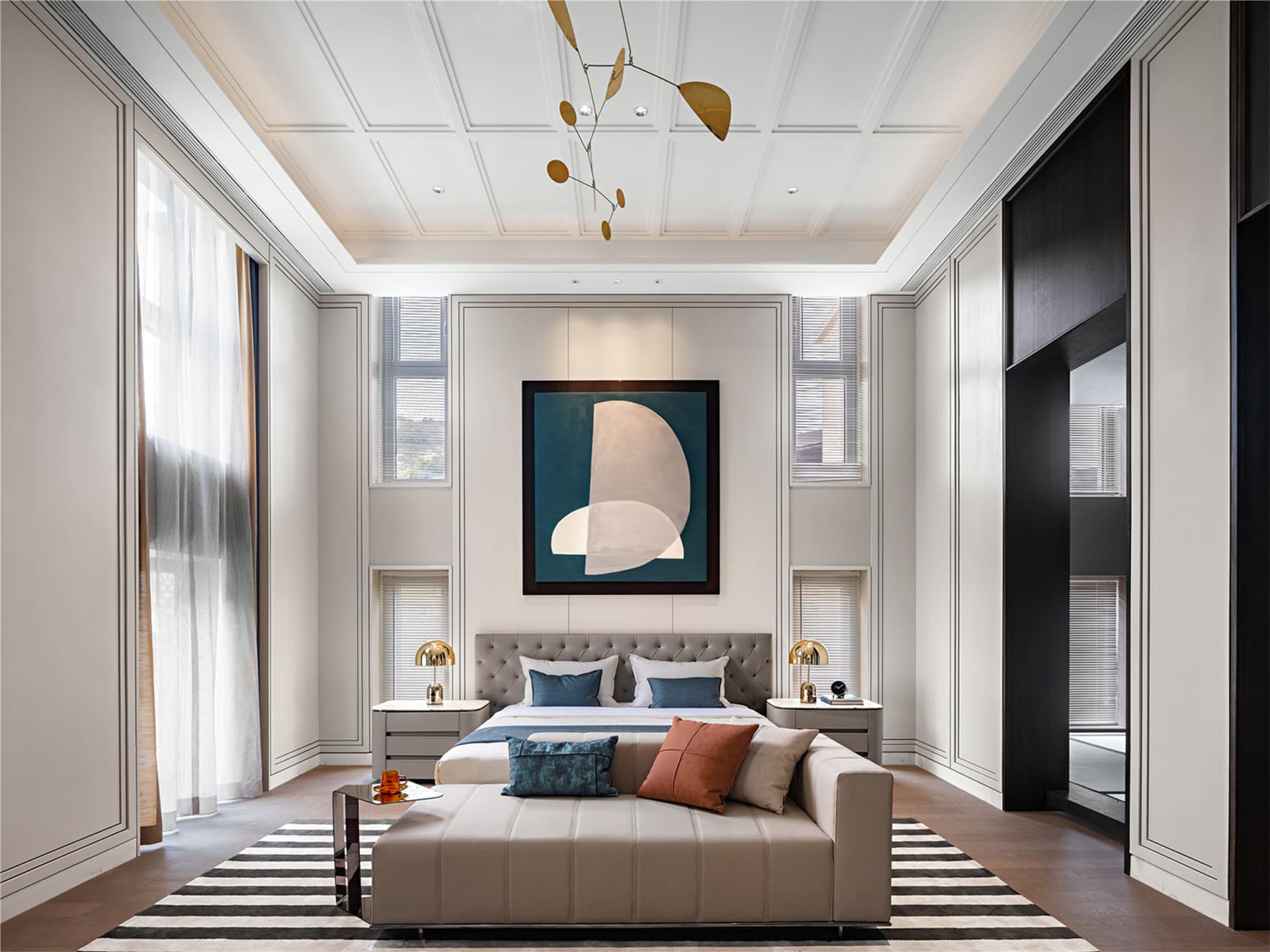 Modern bedroom featuring a bed with neutral-toned bedding, a bench, and abstract art.