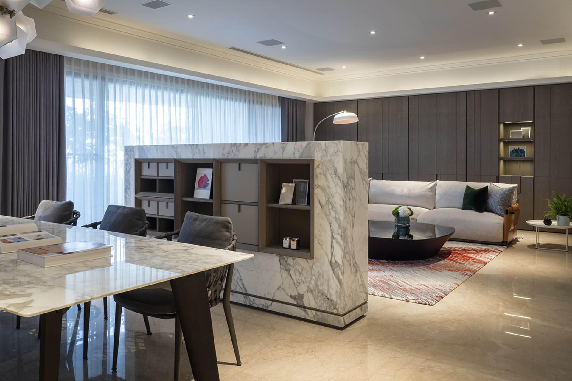 A modern living room featuring a couch with marble-like material