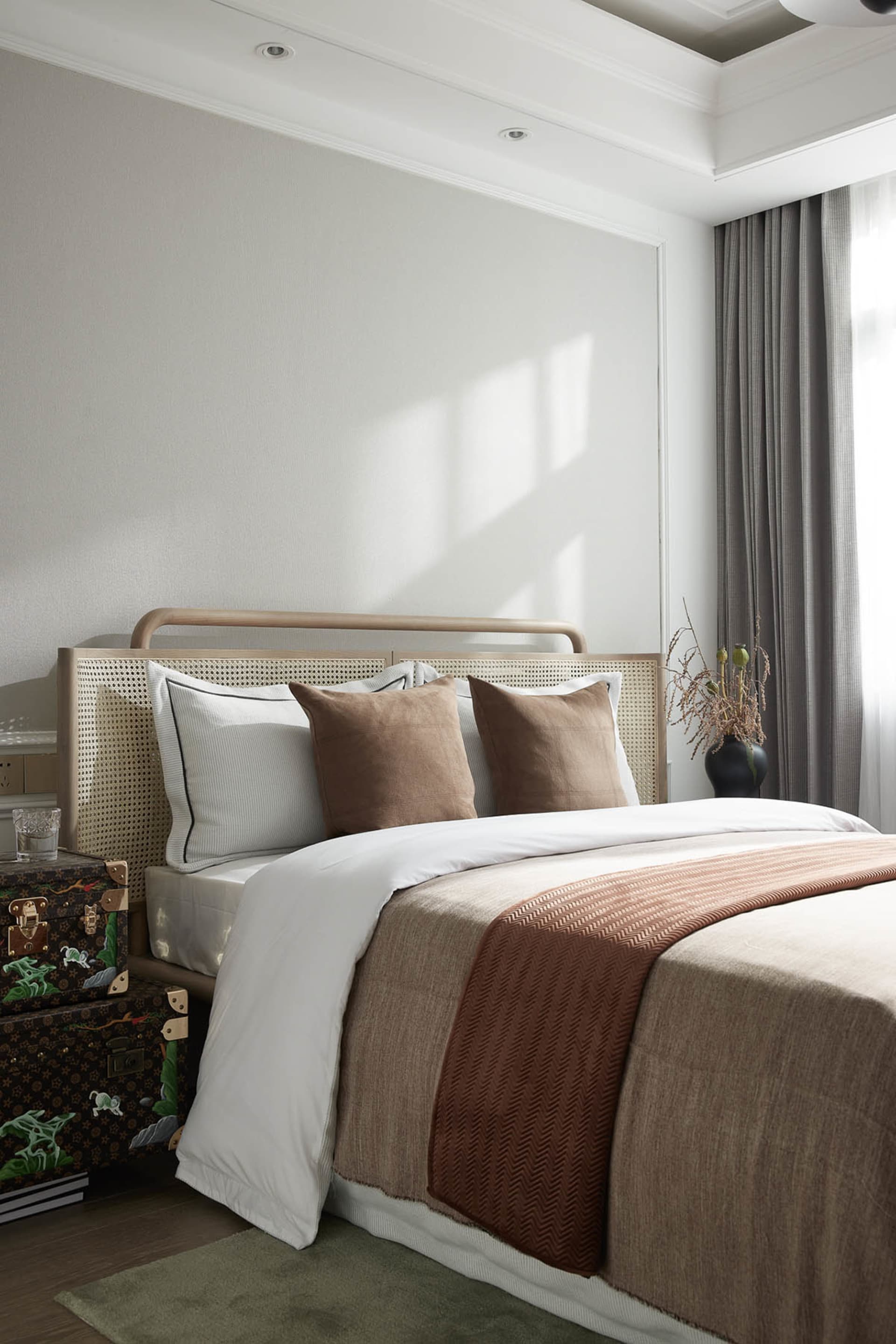 Minimalist bedroom with wooden bed frame, white bedding, and textured fabric accents.