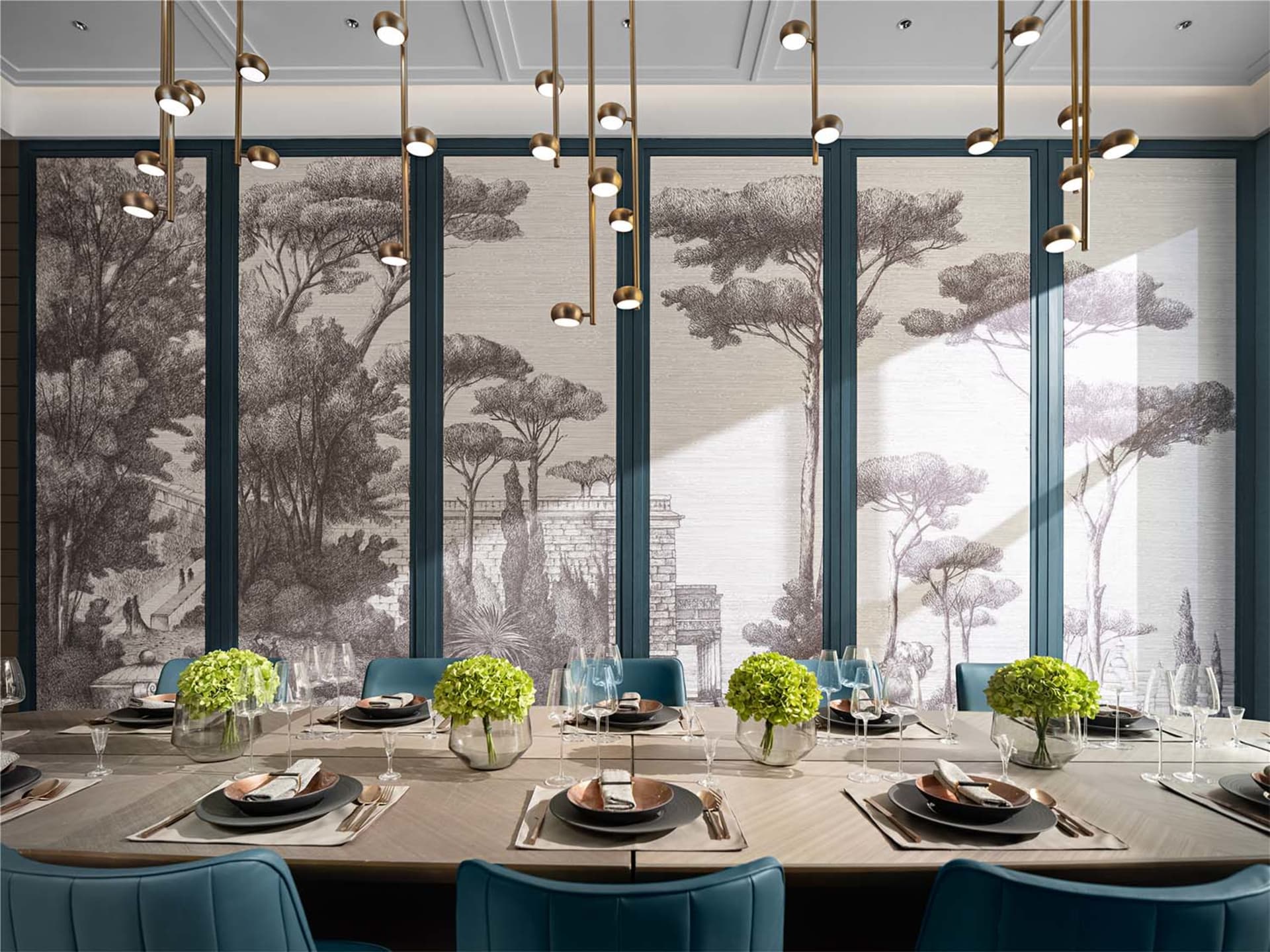 A modern dining room with a long wooden table, blue fabric chairs, and glass pendant lights.