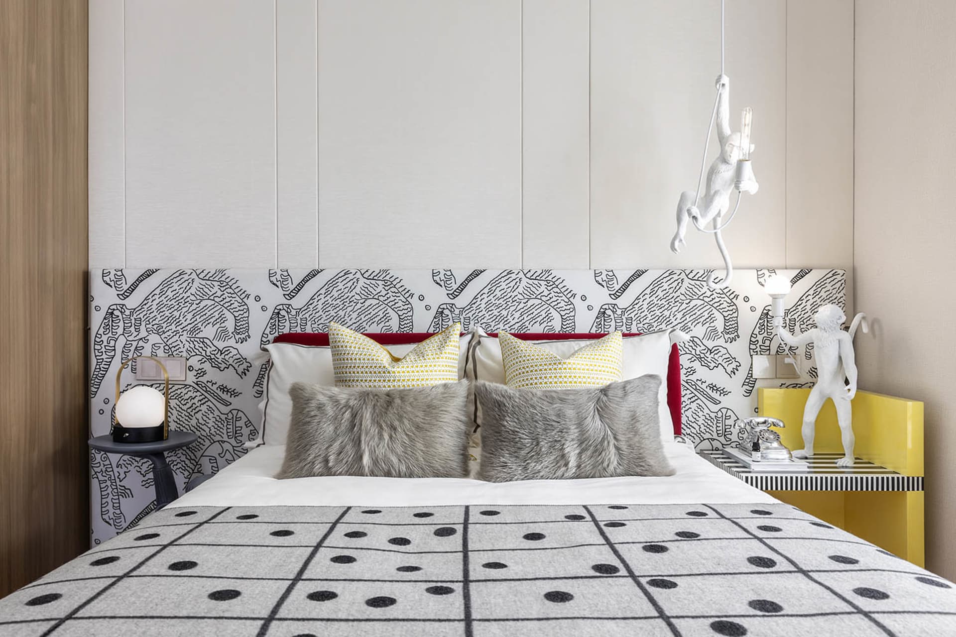 A modern bedroom interior featuring a patterned upholstered headboard and decorative pillows, with a 3D-rendered design.