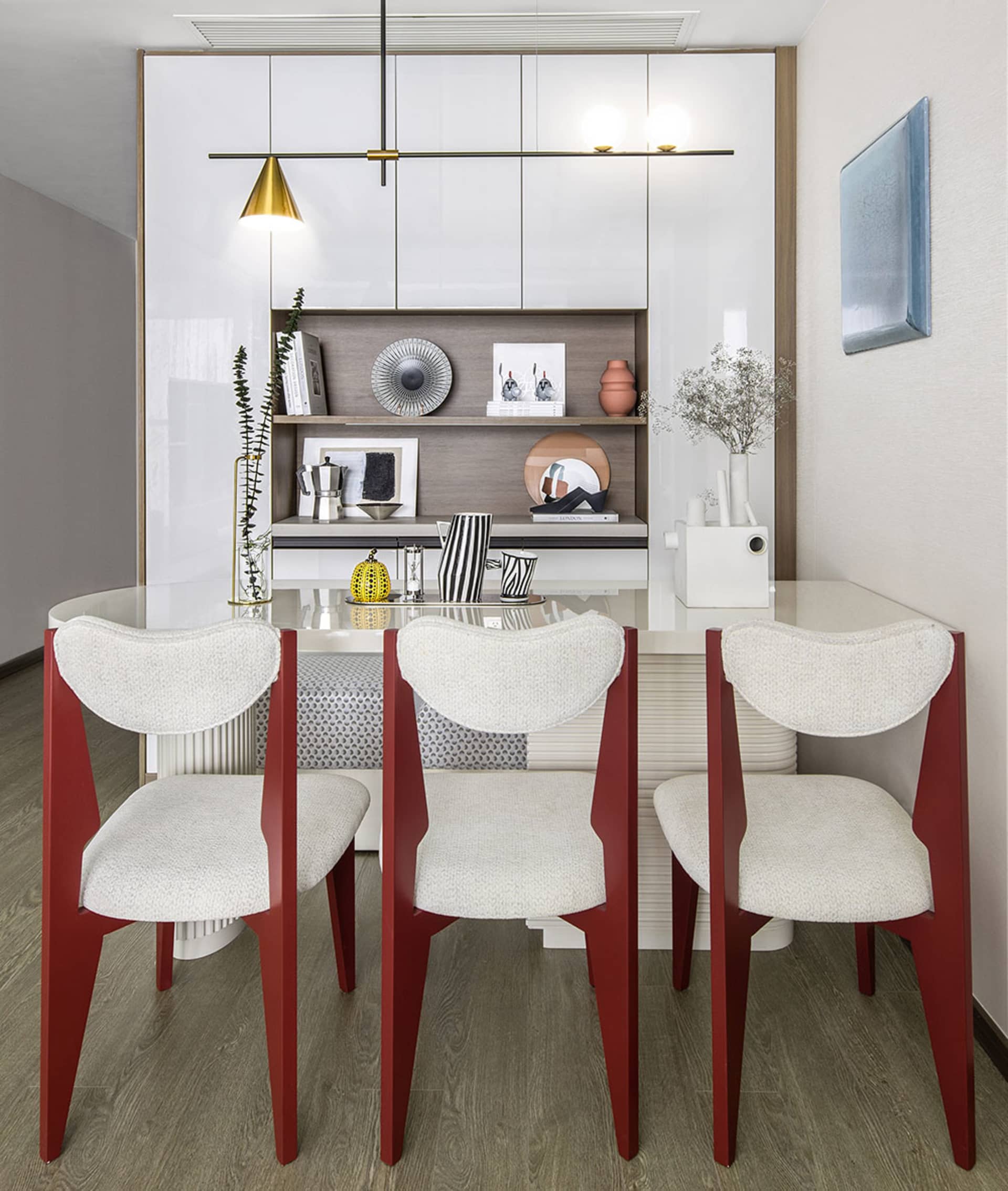 A modern dining room with white furniture and a sleek design.