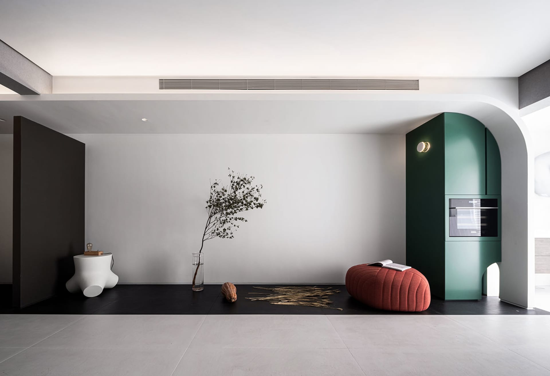 Modern living room featuring a minimalist design with concrete flooring and a sleek, contemporary aesthetic.
