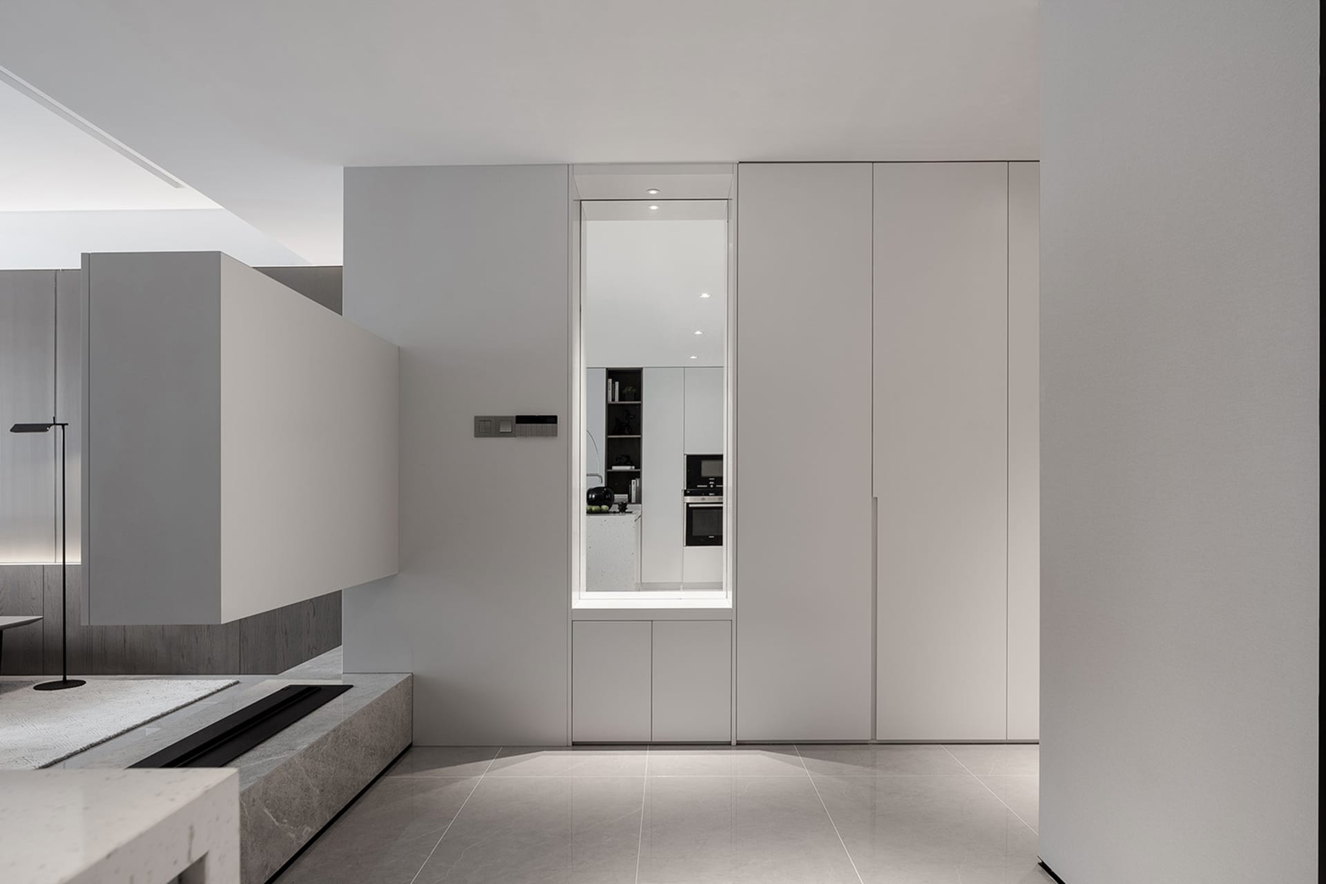 Modern minimalist kitchen with white cabinets and sleek design.