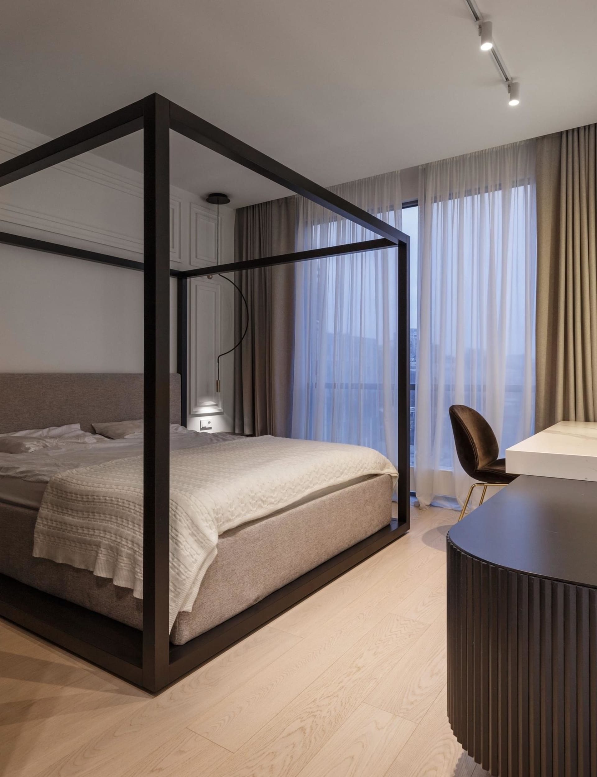 A modern bedroom featuring a frame bed with a minimalist design and a neutral color palette.