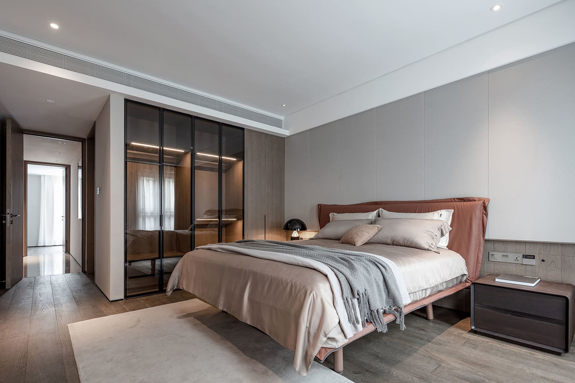 Modern minimalist bedroom featuring wooden furniture and sleek design elements.
