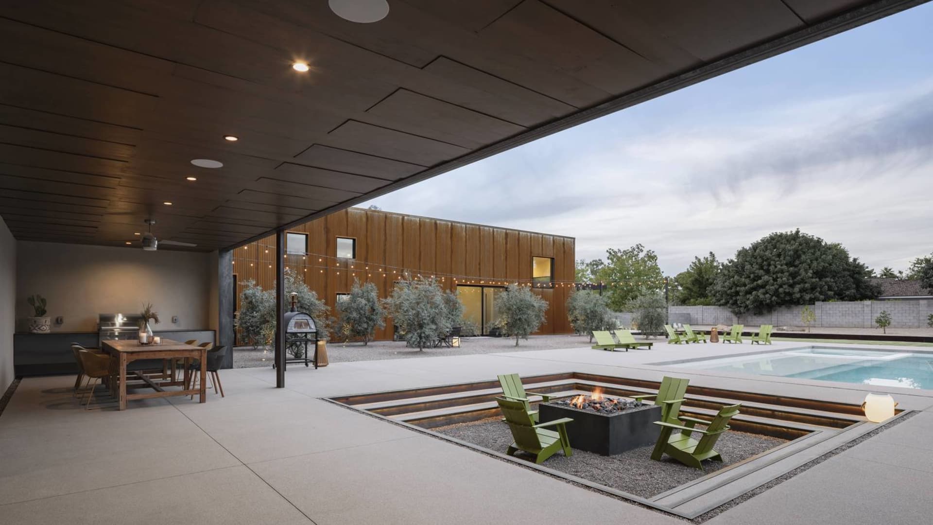Modern residential exterior featuring a clay tile roof and large glass windows.