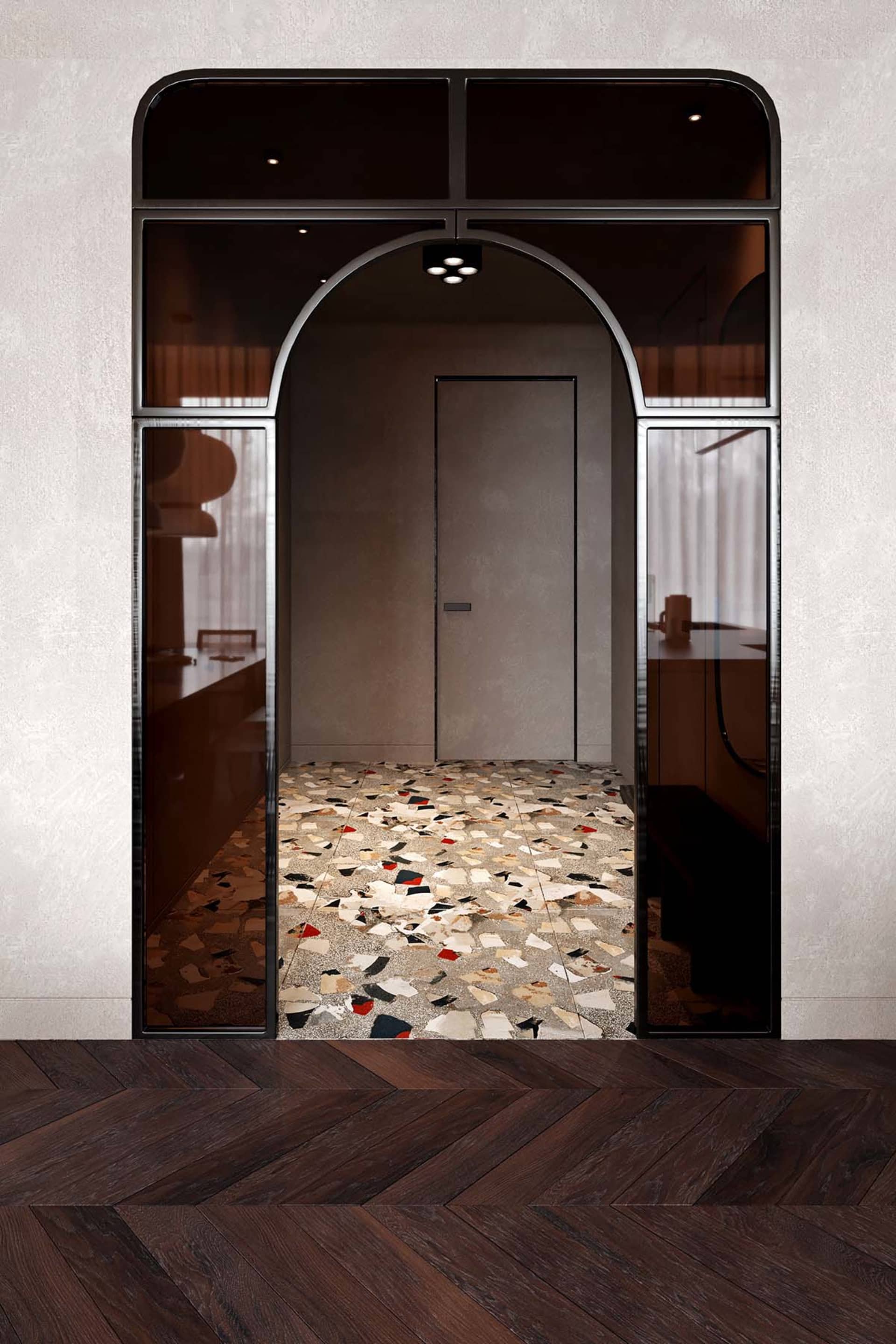 Modern architectural entryway featuring a terrazzo floor with geometric patterns and a large glass window.