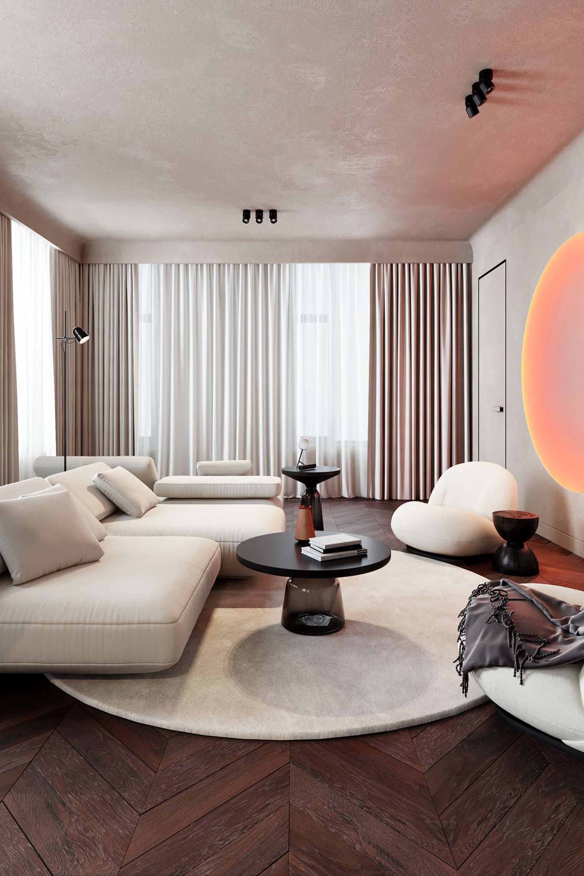 A modern living room with white furniture, textured flooring, and a large circular rug.
