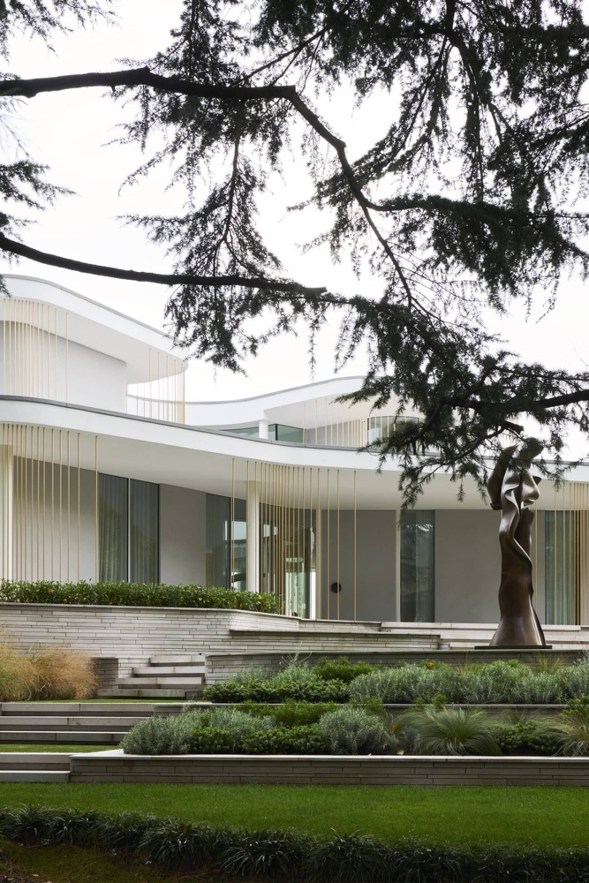 A modern residential exterior featuring light wood and glass.