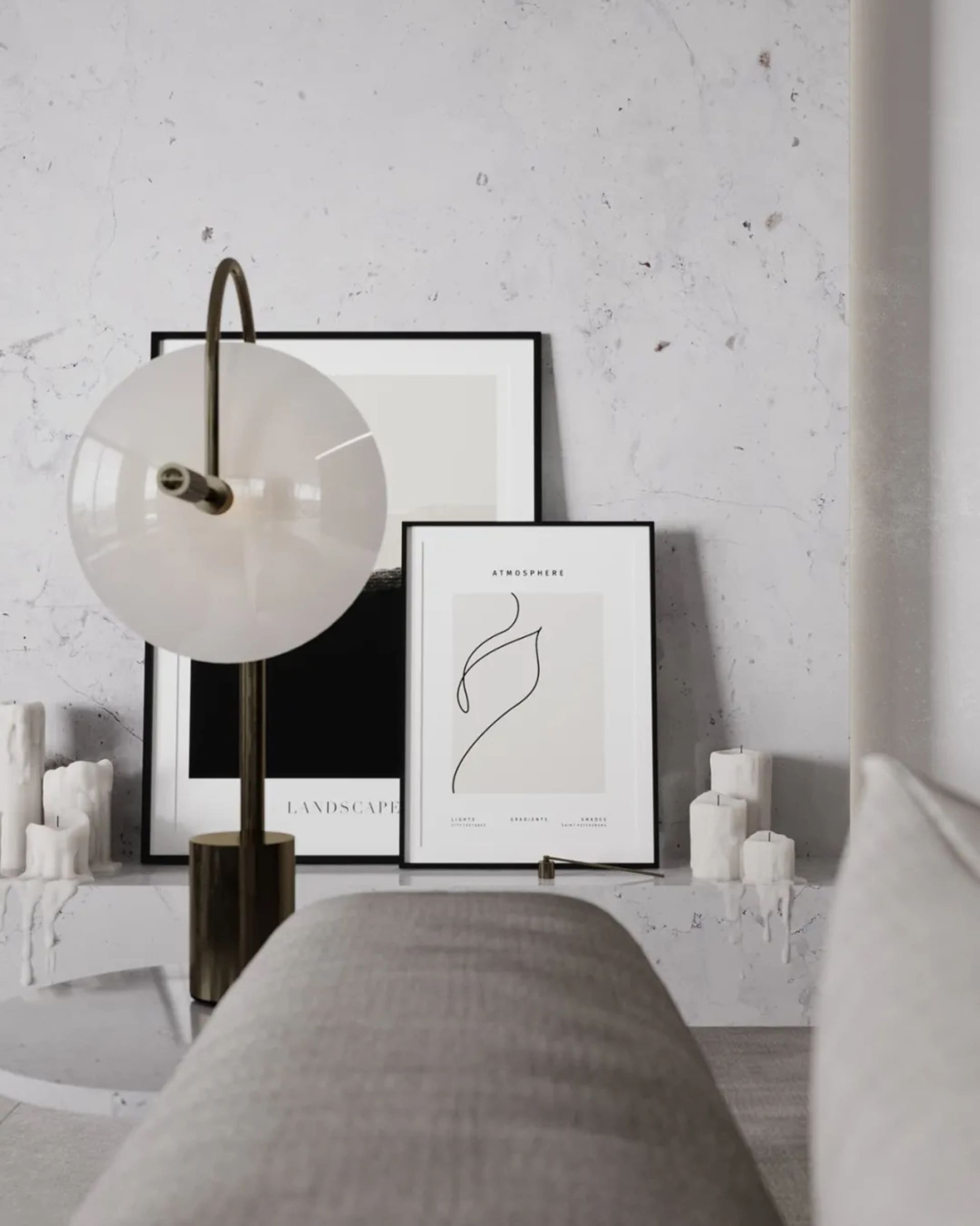 A minimalist living room featuring a bench and a table lamp with candles and framed artworks on the wall.