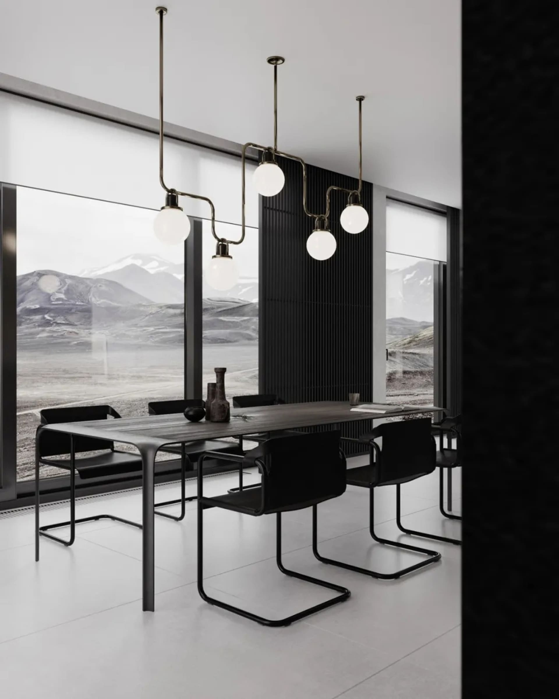 A modern dining room with minimalist design, featuring a metal and glass table and chairs, set against a backdrop of a mounta