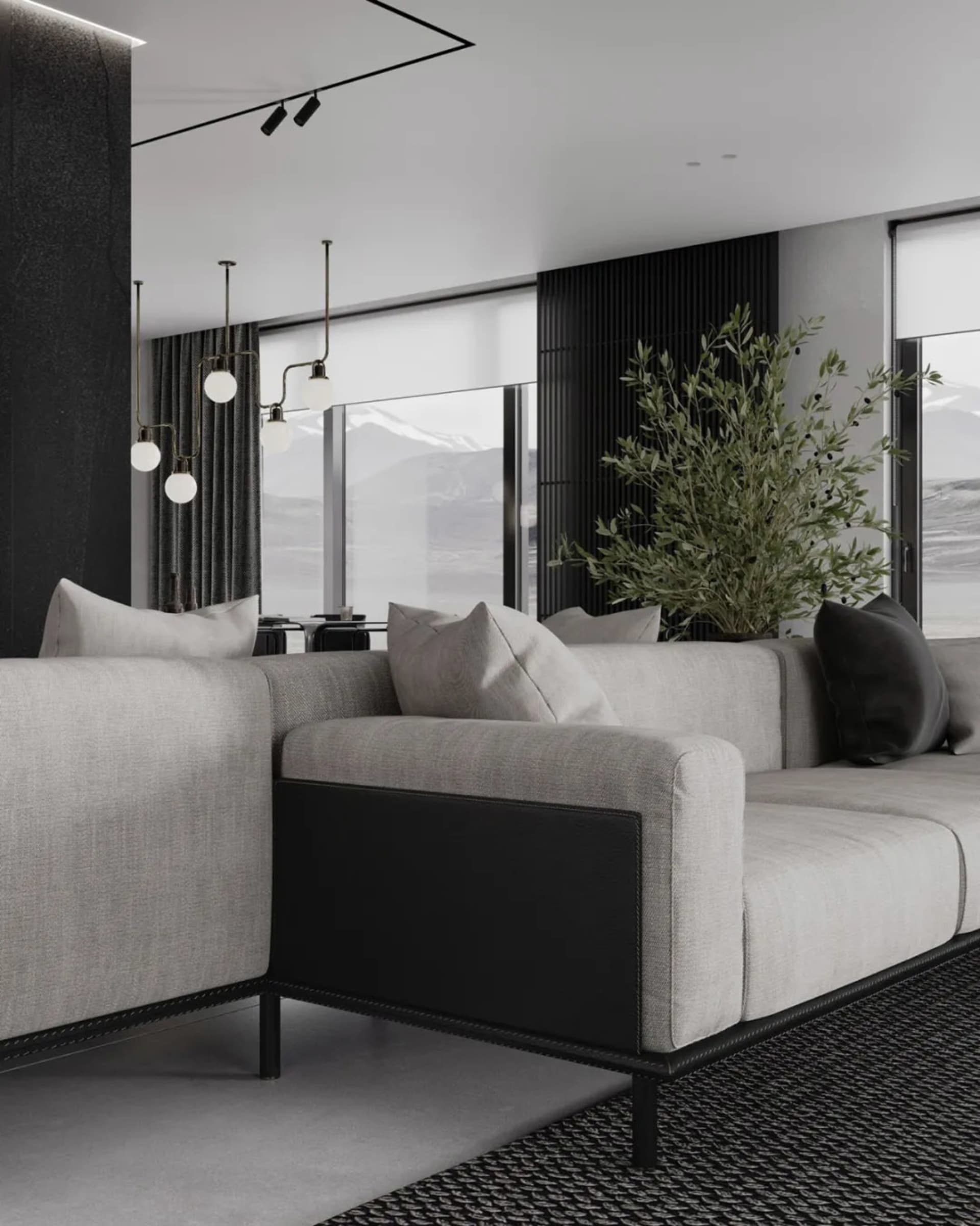 Modern living room featuring a sectional sofa upholstered in fabric and leather, with minimalist decor and large windows.