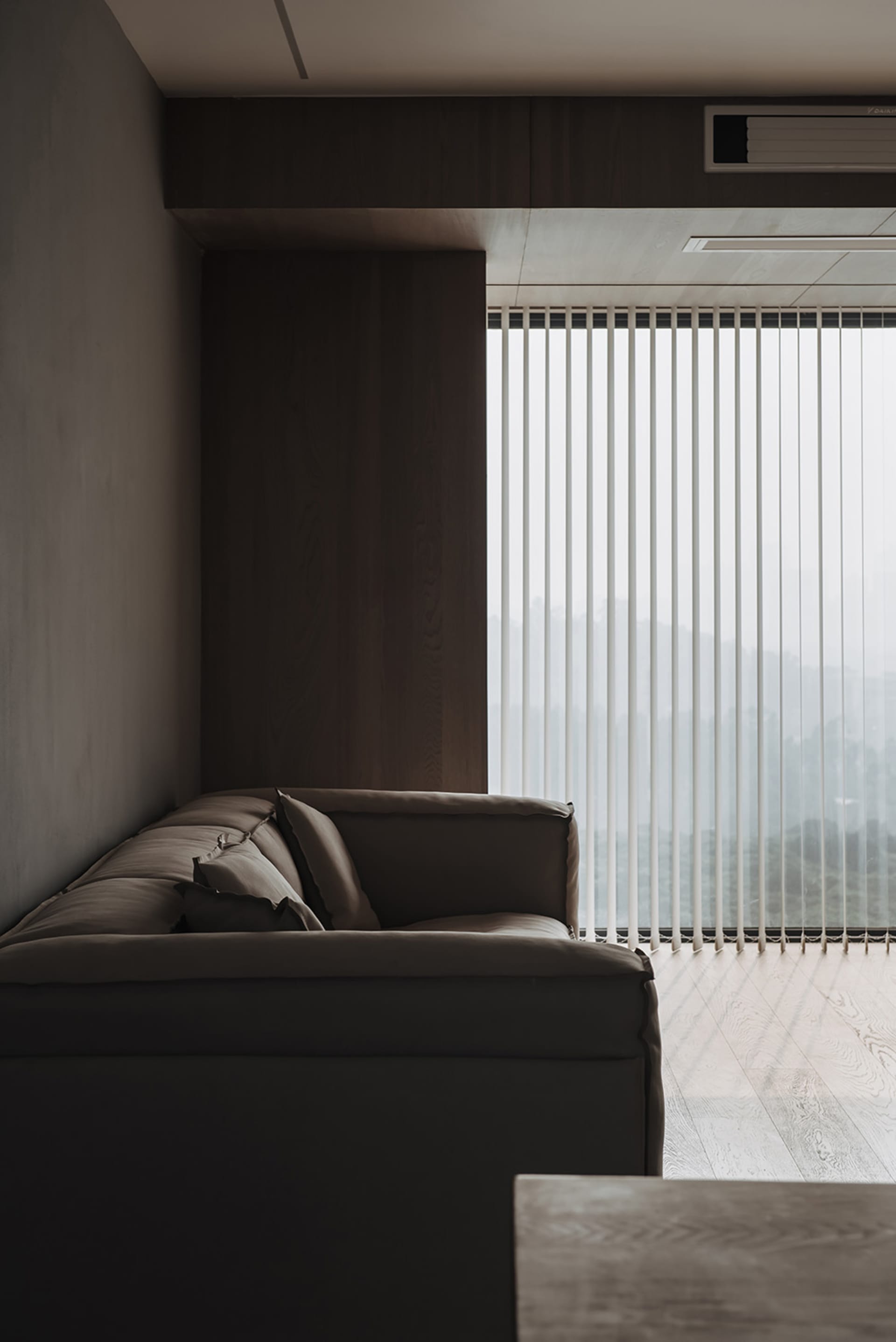 Modern living room featuring a neutral-toned sofa and wooden floor