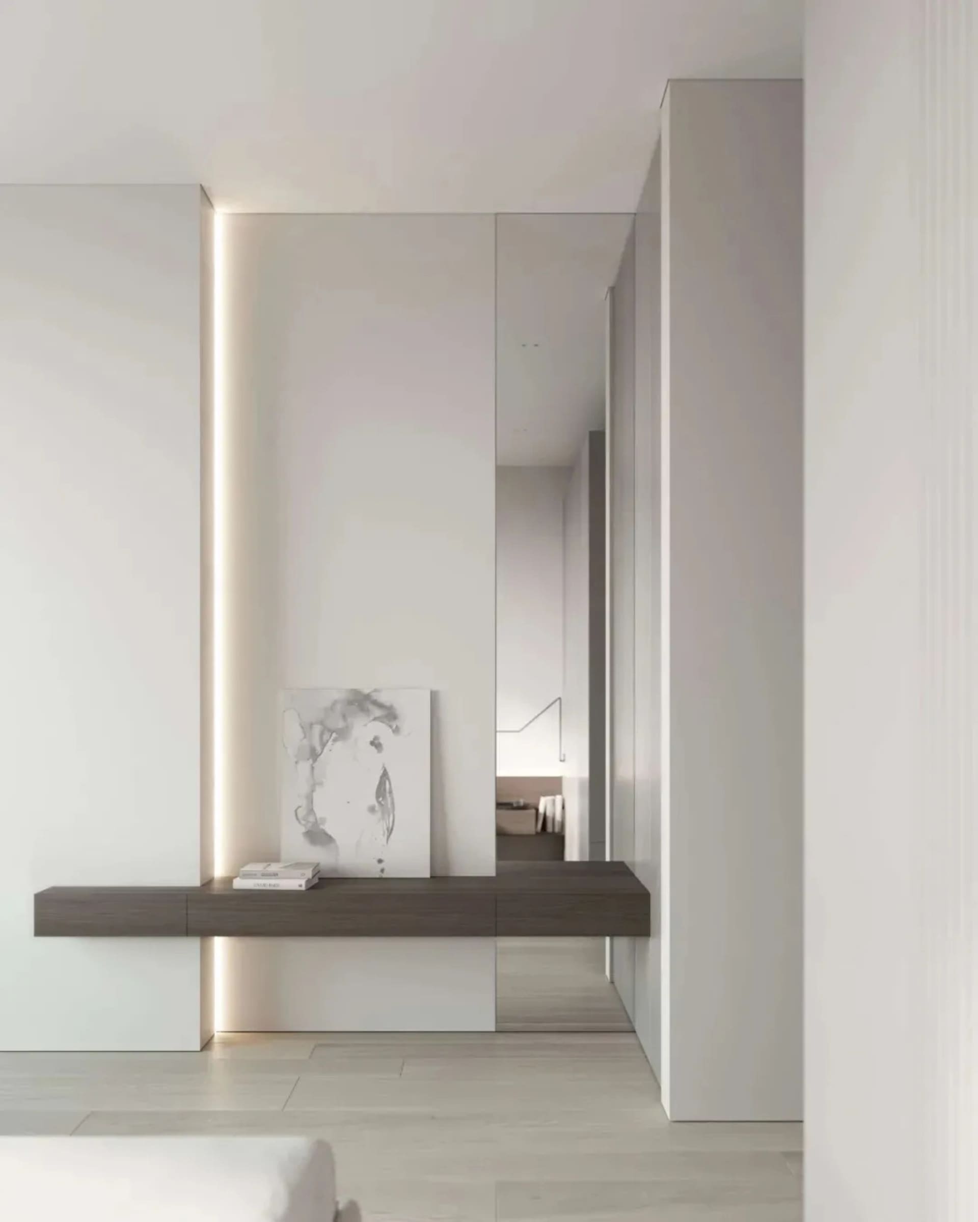 Modern minimalist entryway featuring white walls, wooden floor, glass door, and metal accents.