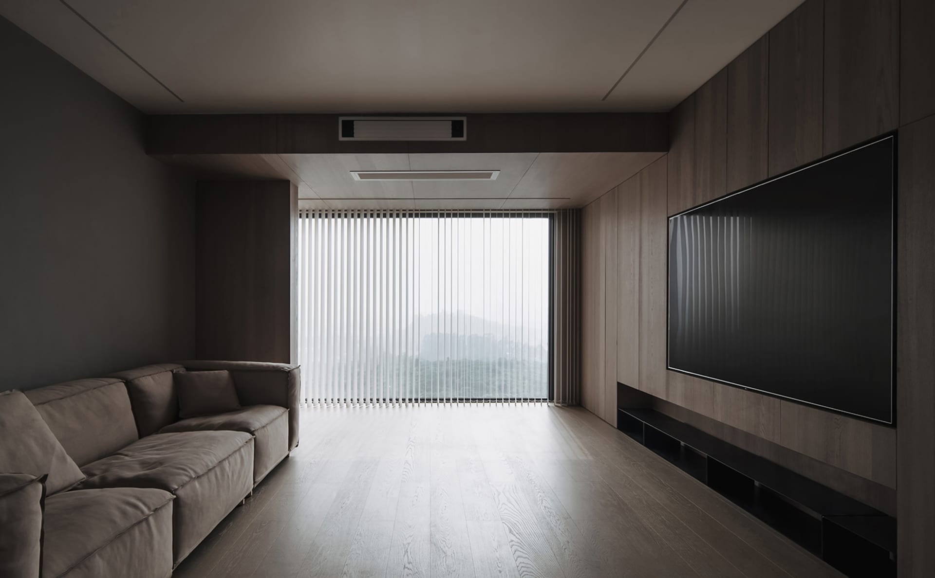 Modern minimalist living room featuring wooden walls and furniture, large television, and floor-to-ceiling windows with verti