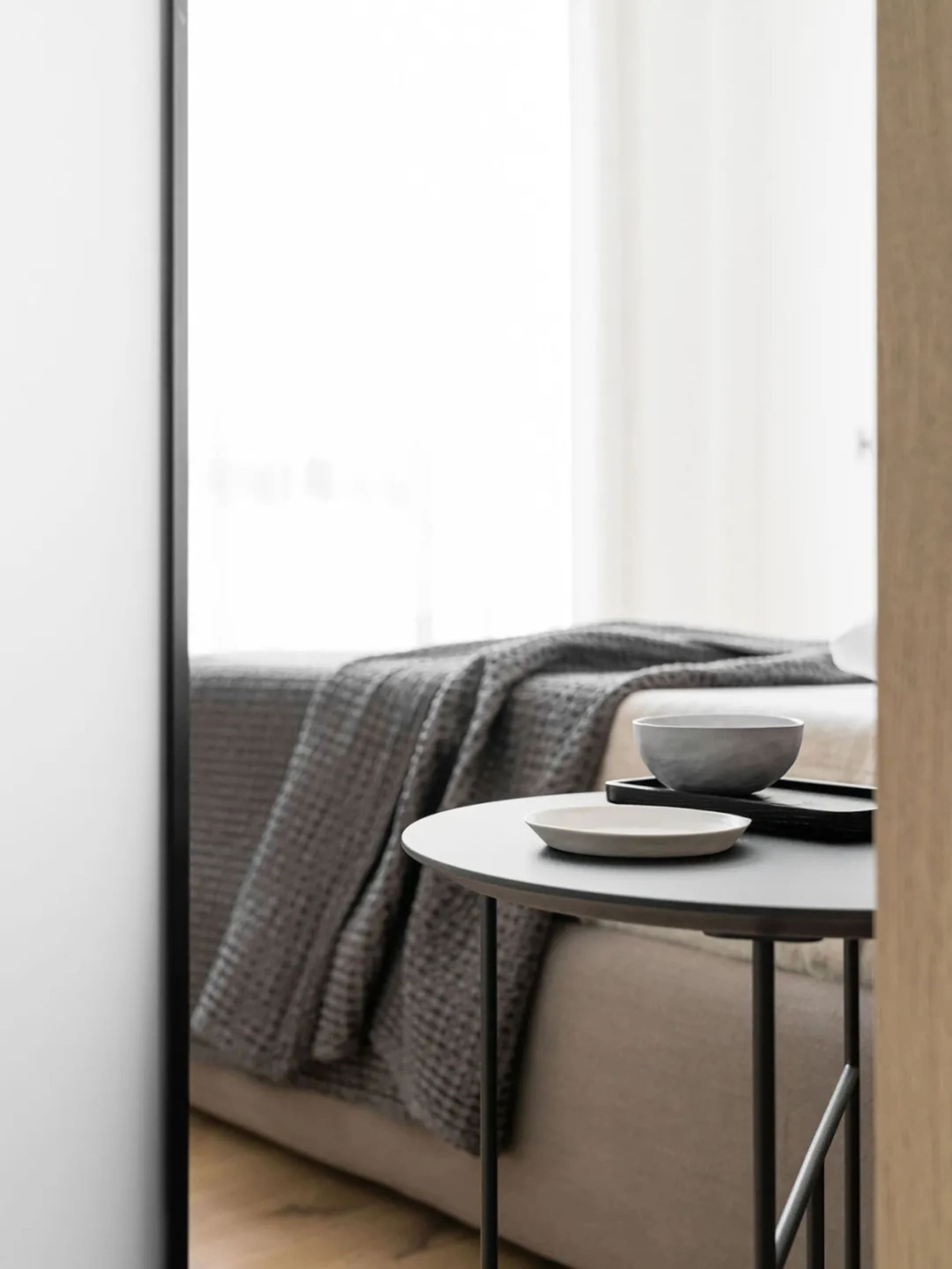 A minimalist living space with fabric and metal elements.