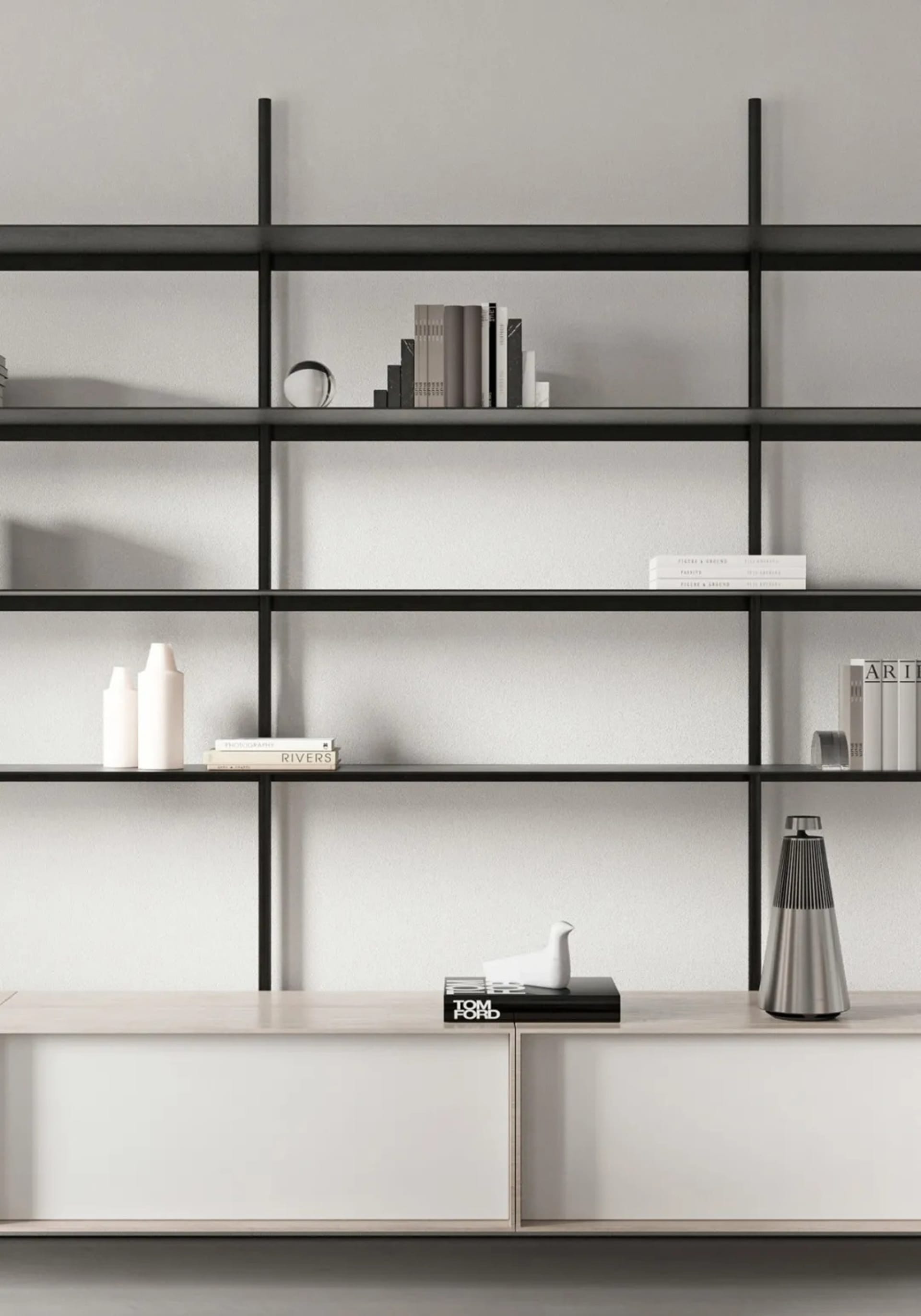A minimalist metal shelf with books and decorative objects.