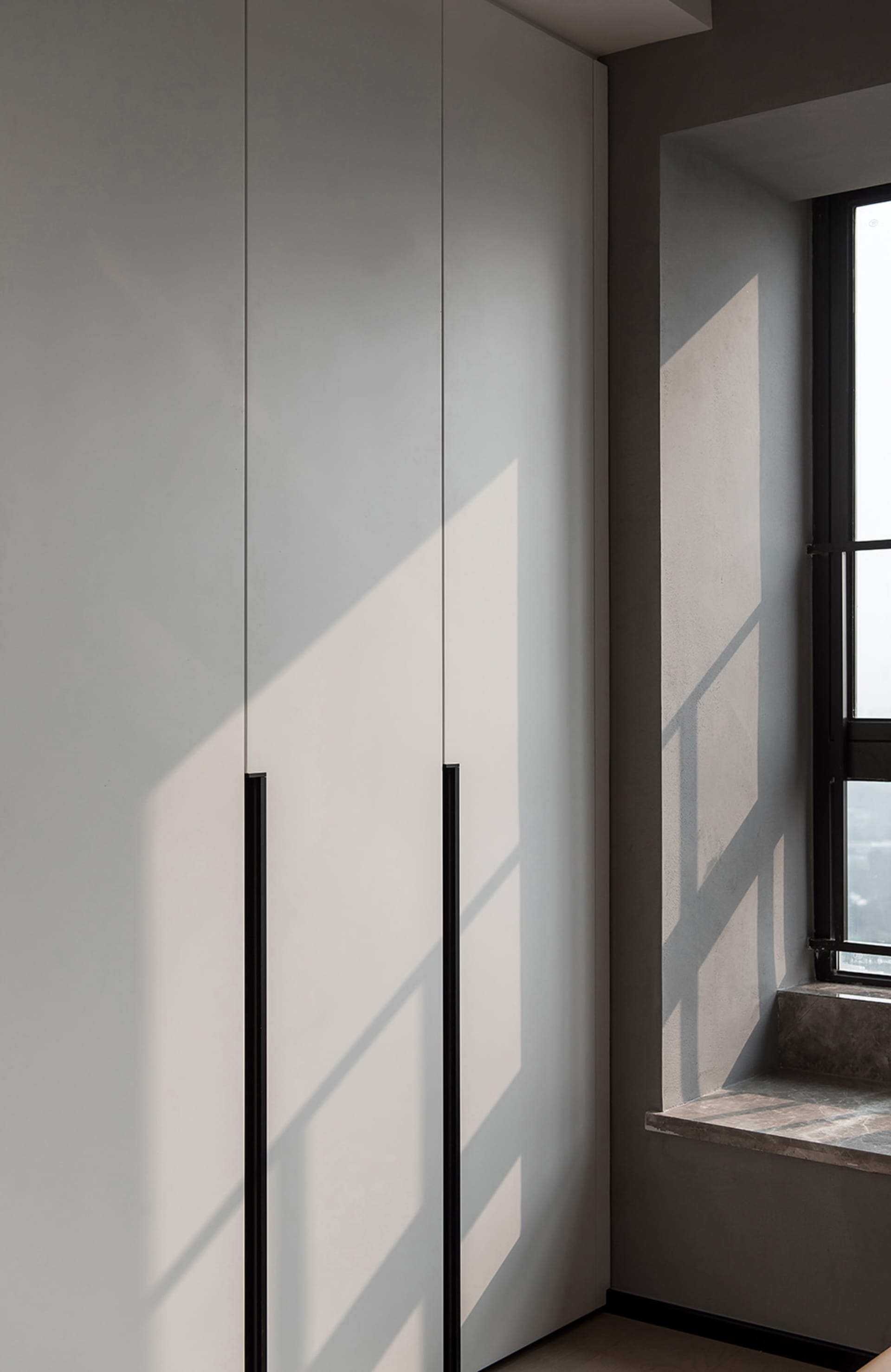 Modern minimalist bedroom featuring a concrete wall and floor.