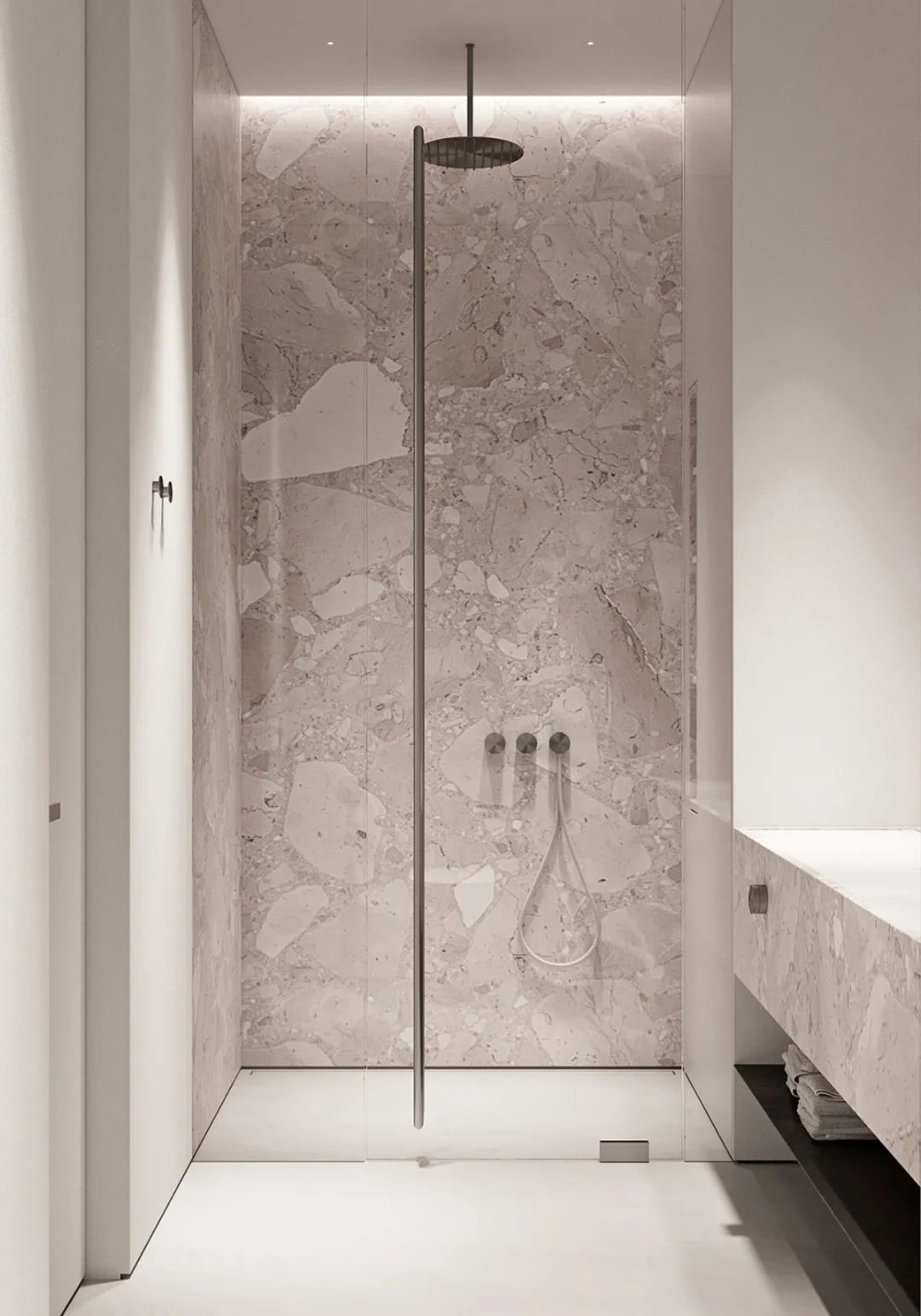 Modern minimalist bathroom with a luxurious marble shower stall.
