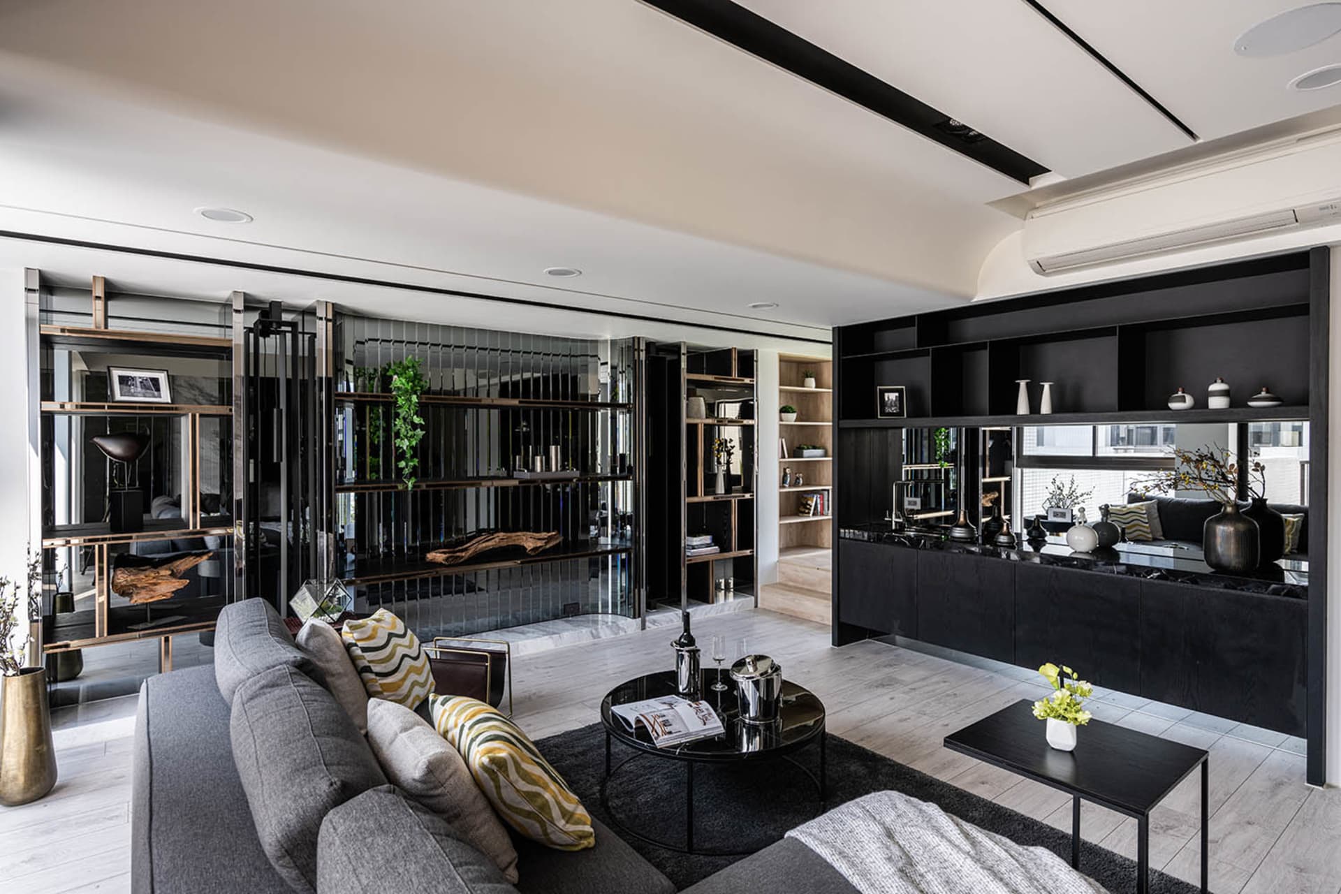 Modern living room with a combination of wood, black metal, acrylic, and glass materials.