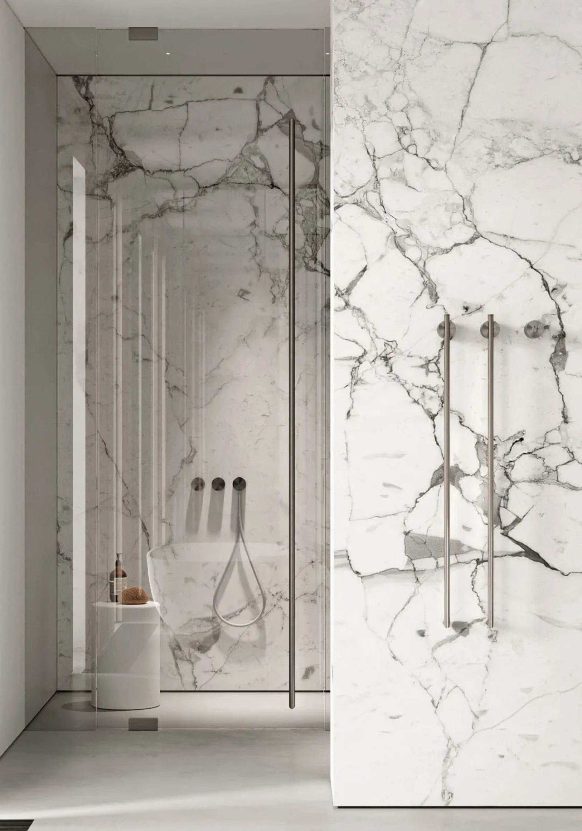 A modern bathroom with marble walls and glass shower enclosure.