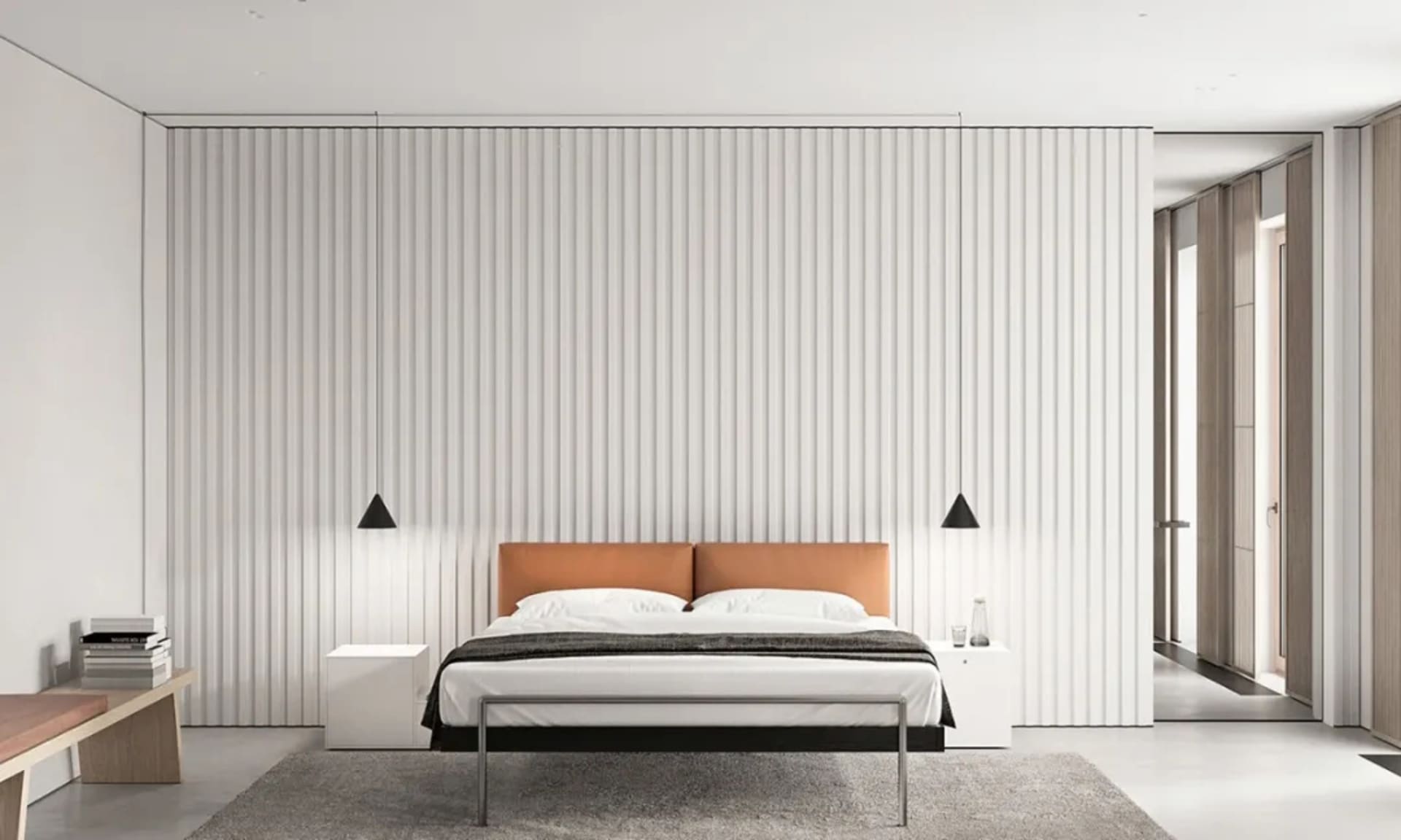 Minimalist bedroom with a orange headboard, white walls, and metallic frame bed.