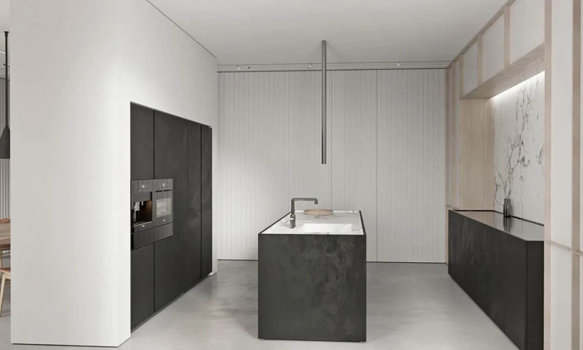 A modern kitchen with a central island featuring a concrete countertop and floor-to-ceiling cabinets.
