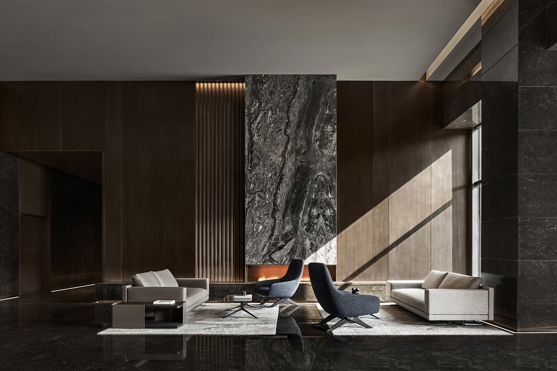 Modern living room with concrete and marble elements, featuring a dark floor and minimalist design.