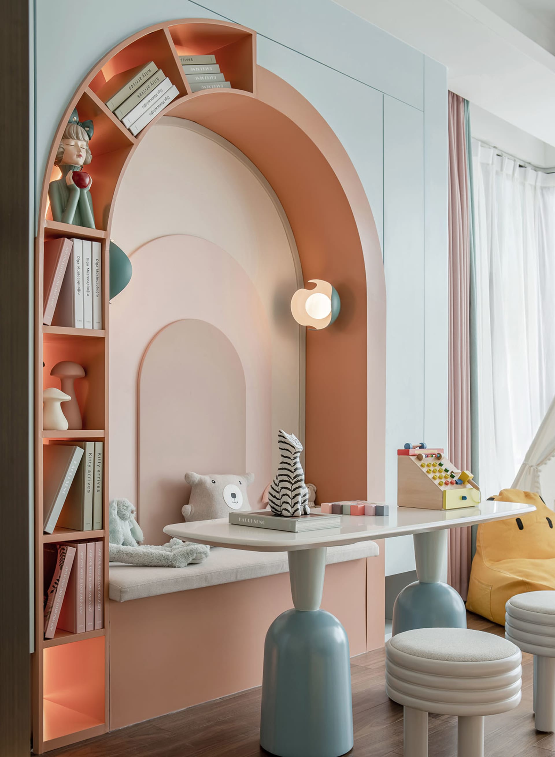 A modern children's playroom with shelves, seating area, and toys.