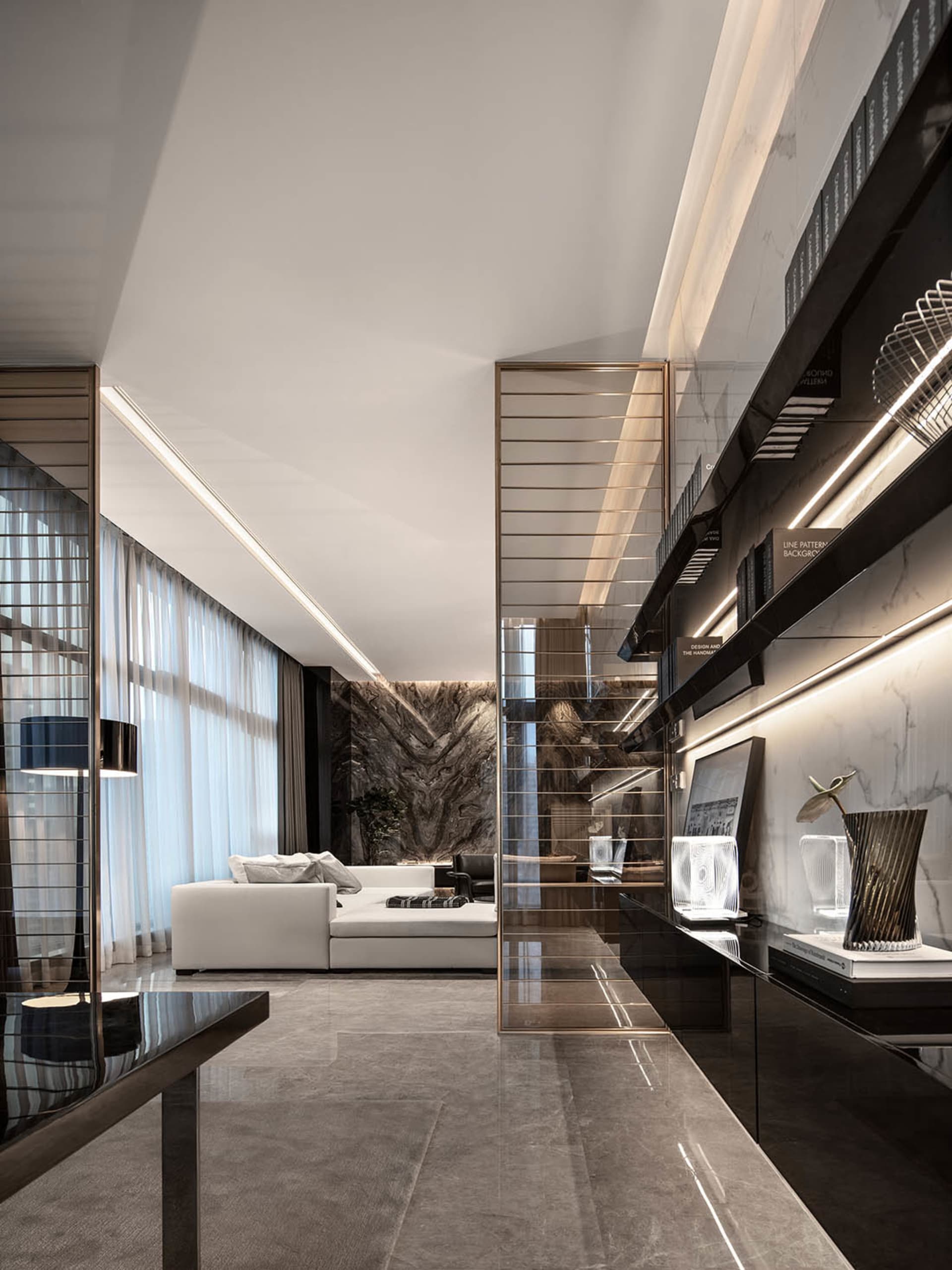Modern, minimalist living room featuring white furniture and marble elements.