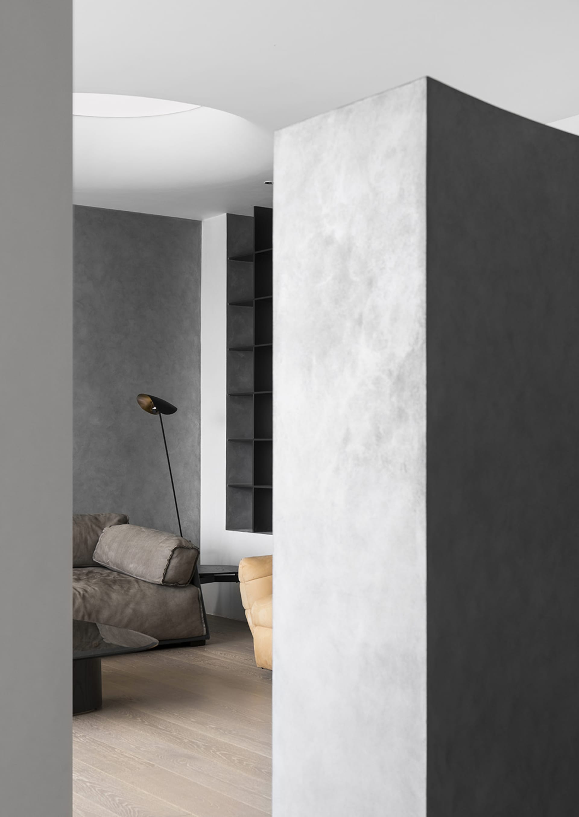 Concrete living room interior with modern furniture and minimalist design elements.