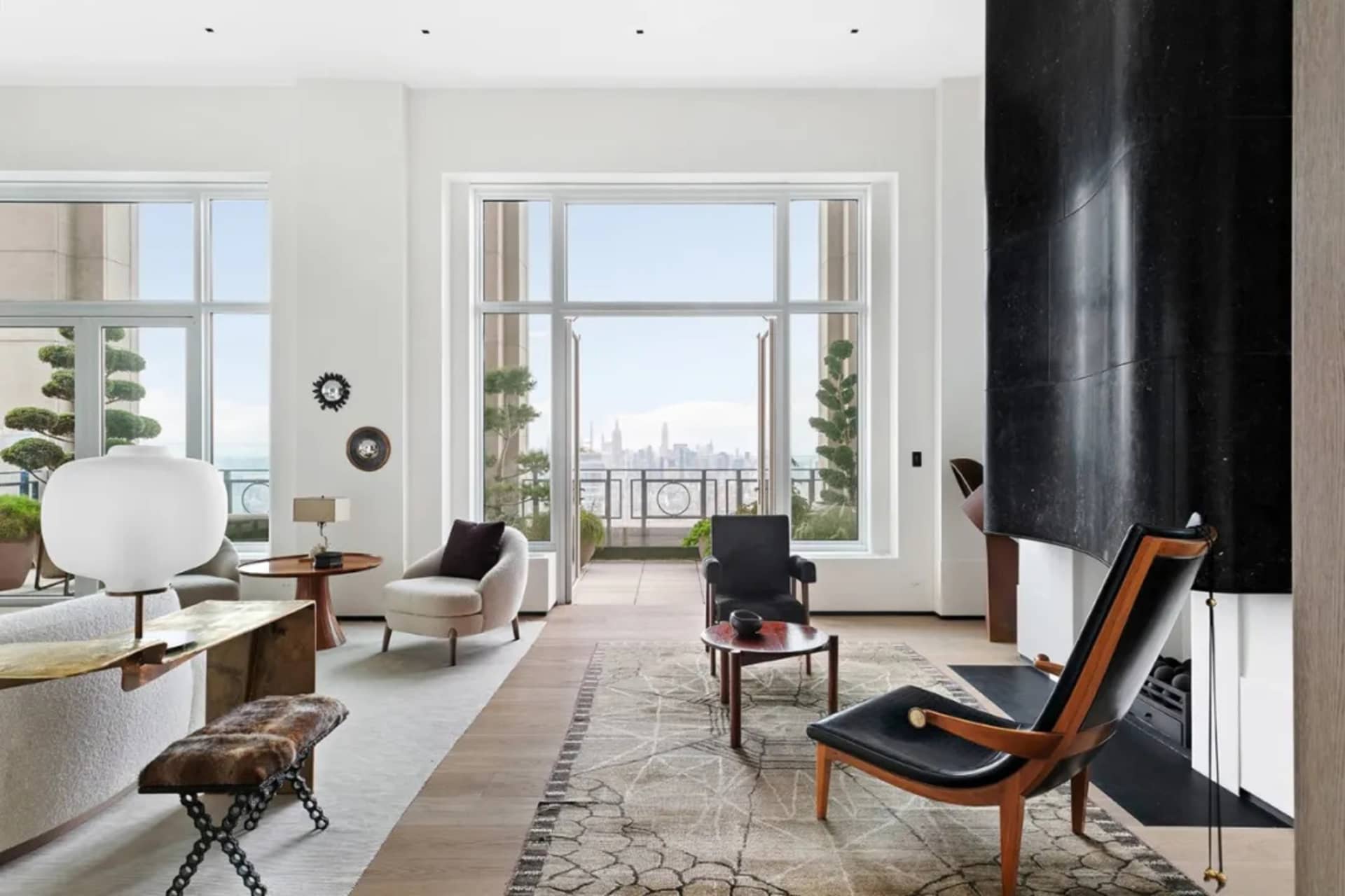 Modern living room featuring marble, leather, and glass materials.