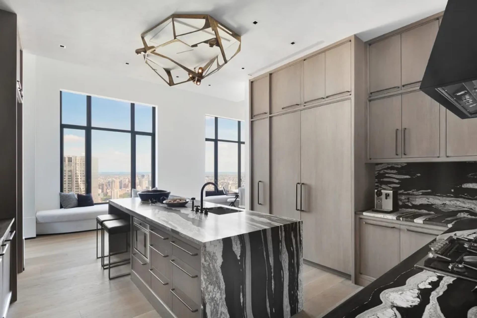 Modern minimalist kitchen featuring marble countertops and wooden cabinets.