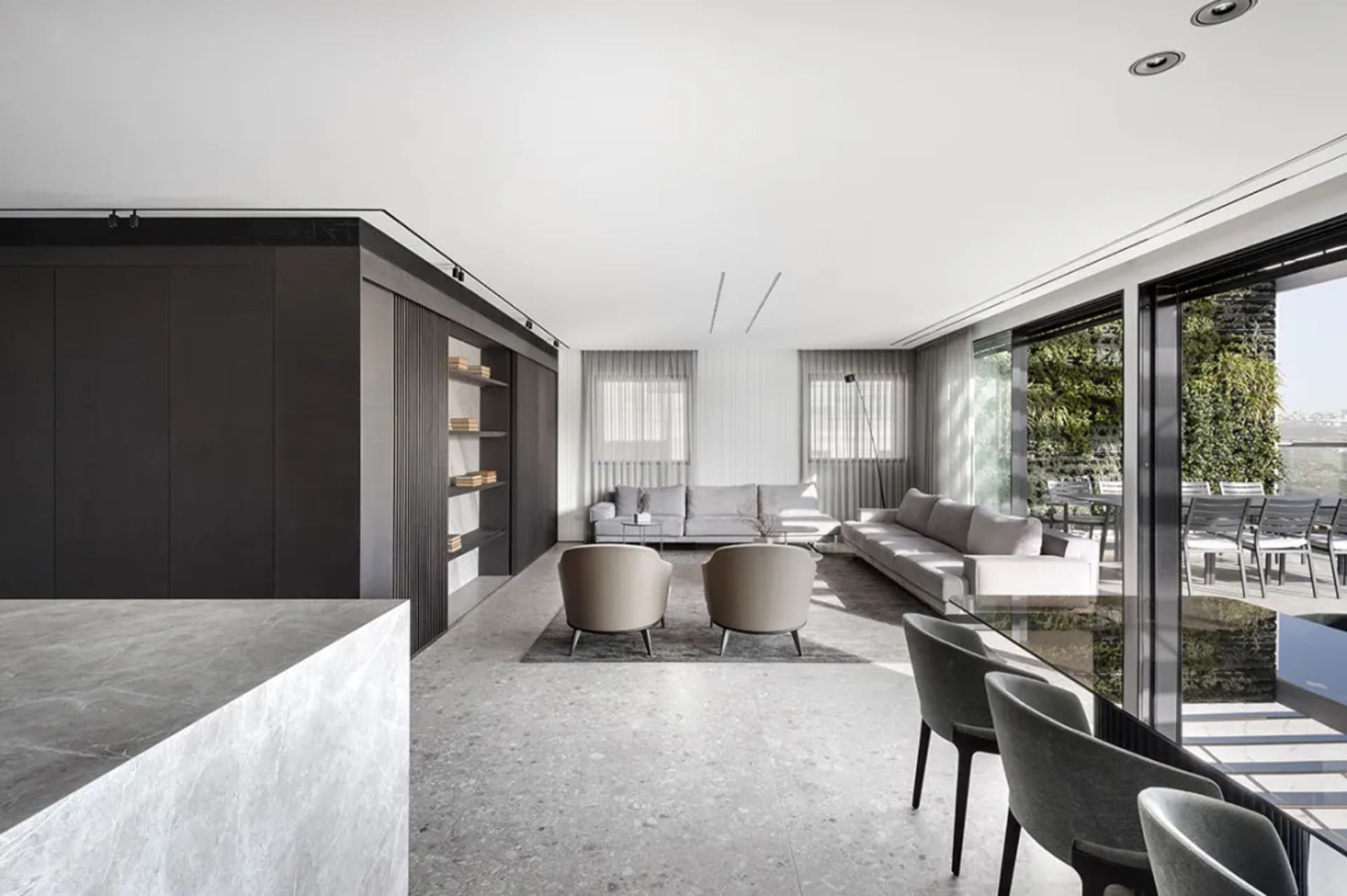 Modern living room featuring a sleek, contemporary design with concrete flooring and minimalistic furniture.