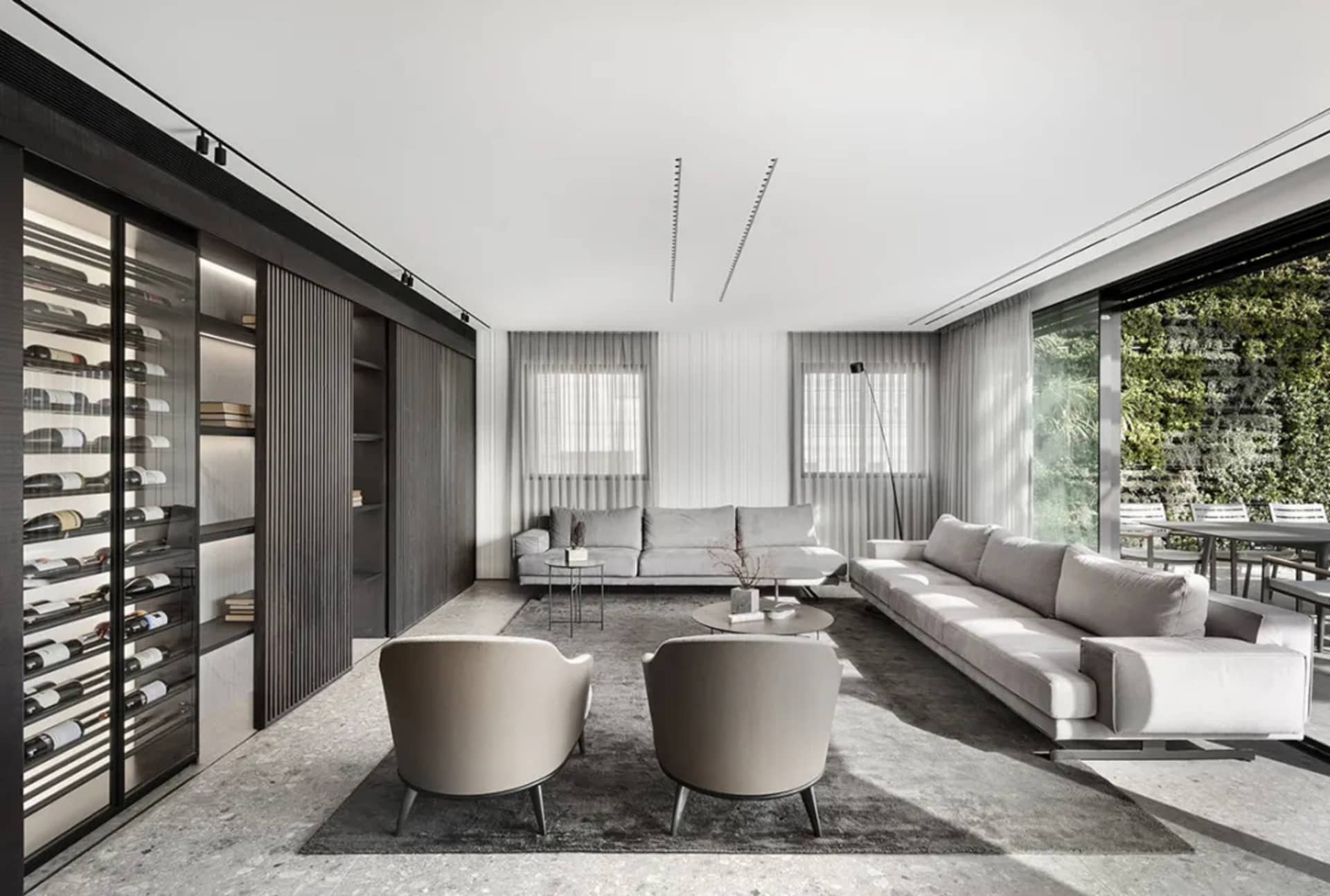 Modern living room featuring glass windows, fabric sofas, and wood accents.