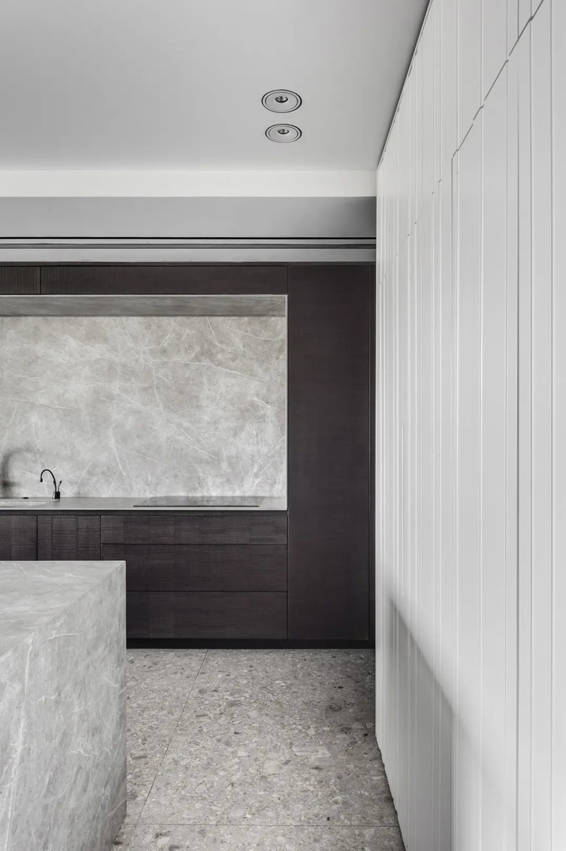 Modern kitchen featuring marble countertops and floor tiles