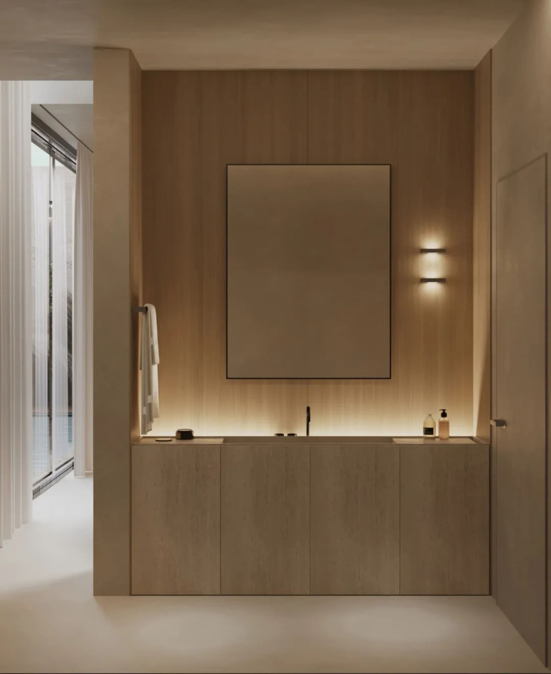 Minimalist bathroom with wooden walls featuring a large rectangular mirror and wooden vanity with integrated sink, illuminate