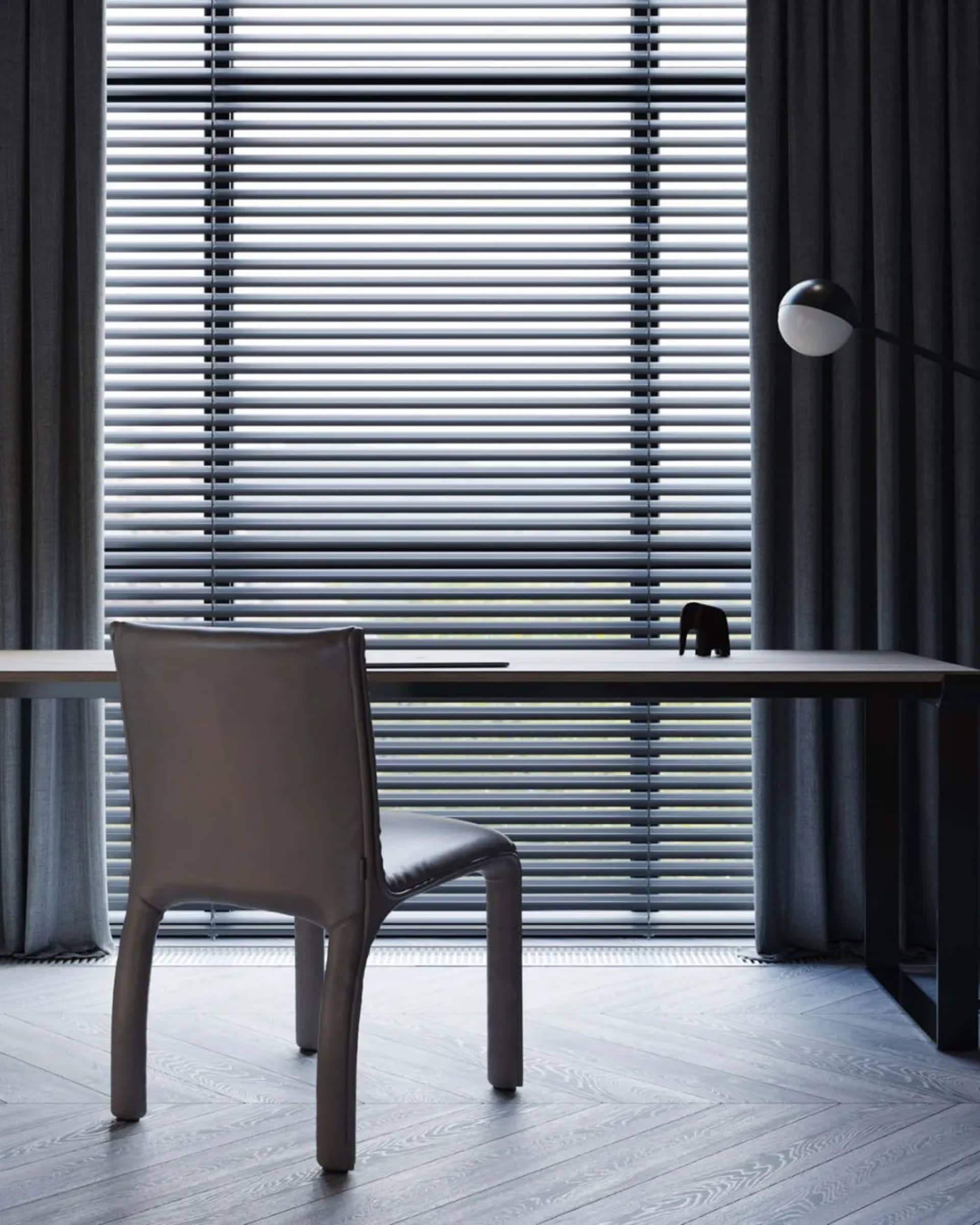 Modern home office featuring a wooden desk and chair with a minimalist design aesthetic.