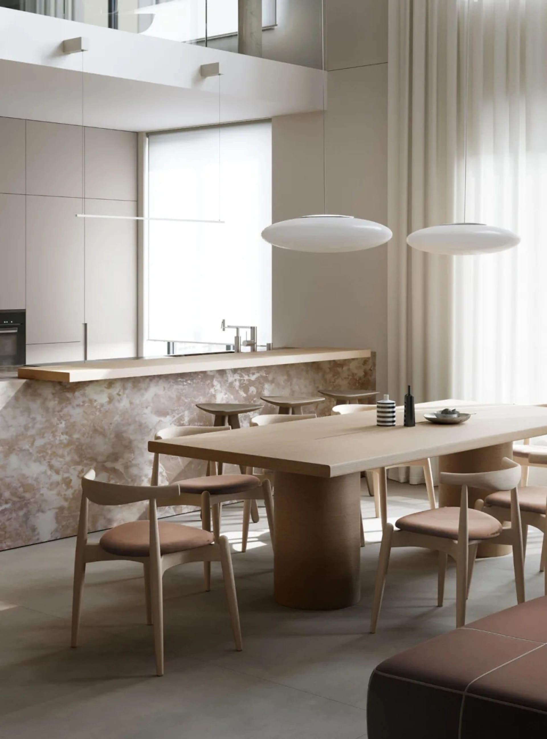 Modern residential kitchen featuring marble counter tops and minimalist design elements.