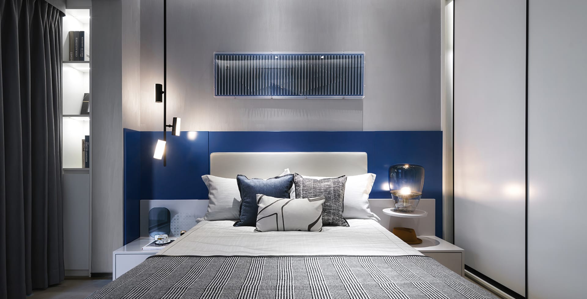 Modern bedroom featuring metallic accents and fabric upholstery, showcasing contemporary design elements.
