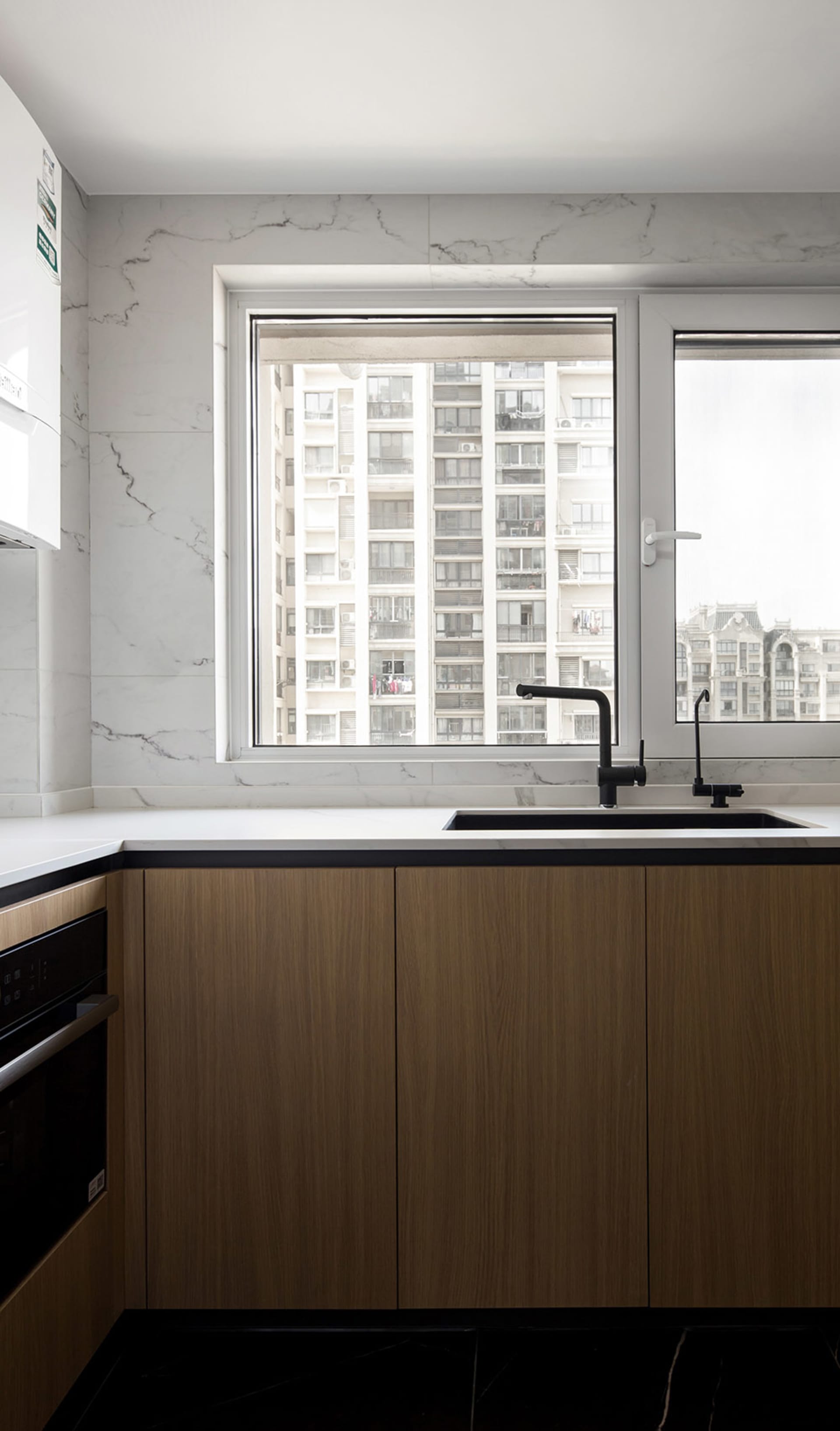 Modern kitchen with marble backsplash and black accents
