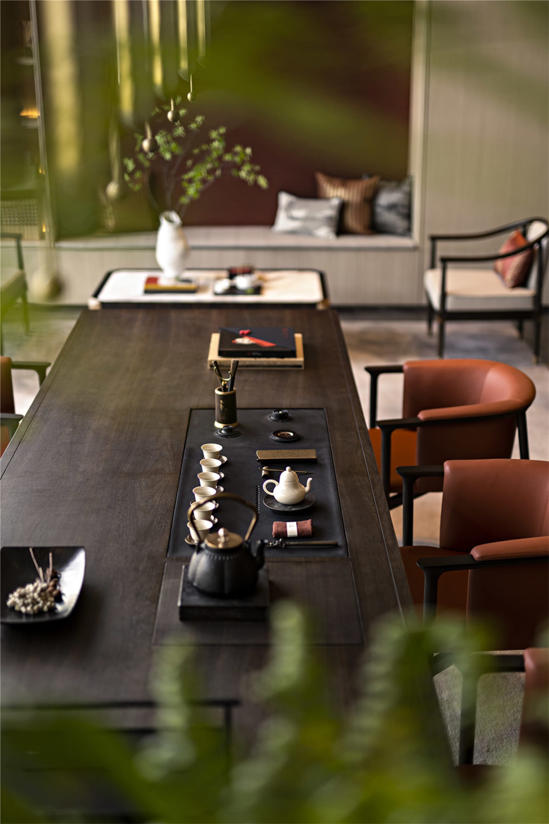 Modern living room with wooden table, leather chairs, and glass vase.