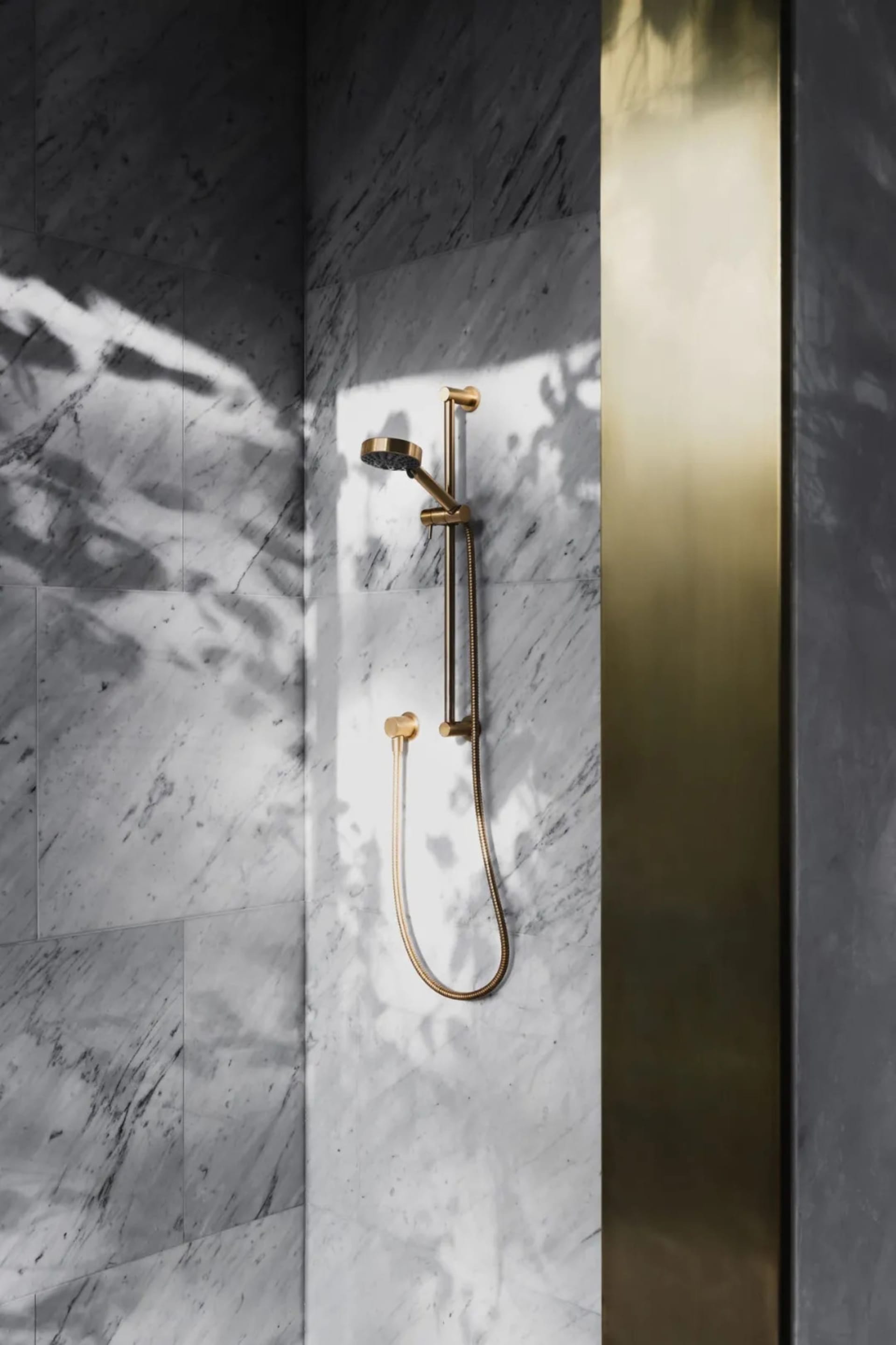 Modern minimalist bathroom with marble shower head.