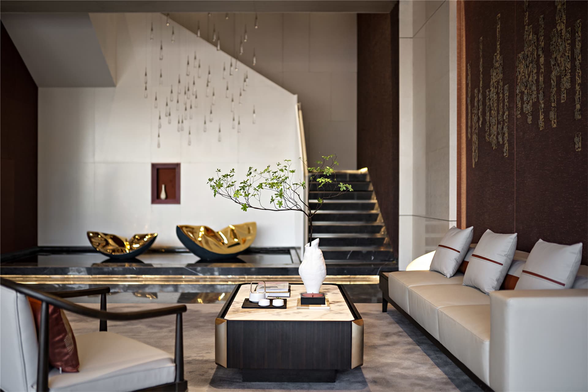 Modern minimalist living room with concrete walls, marble accents, and metallic furniture.