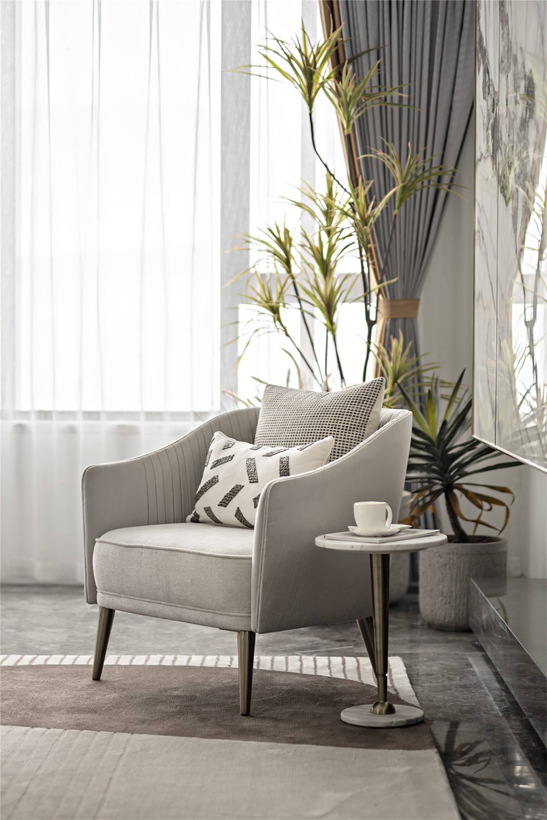 A modern fabric armchair in a contemporary living room setting, featuring minimalist design and plush seating.