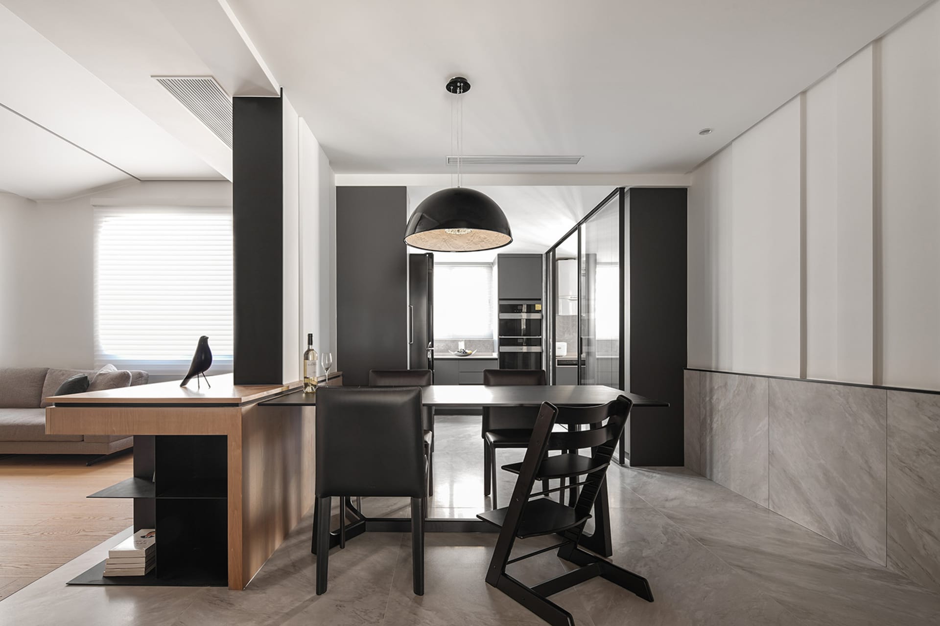 Modern minimalist kitchen with a breakfast bar made of wood and metal materials.
