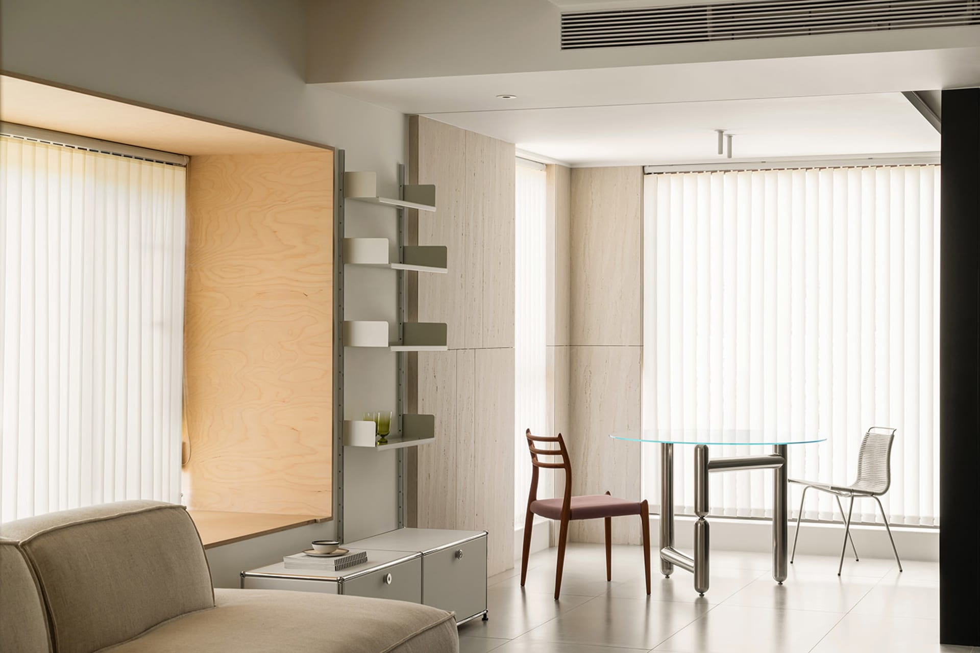 Modern, minimalist living room with neutral tones and simple furnishings.