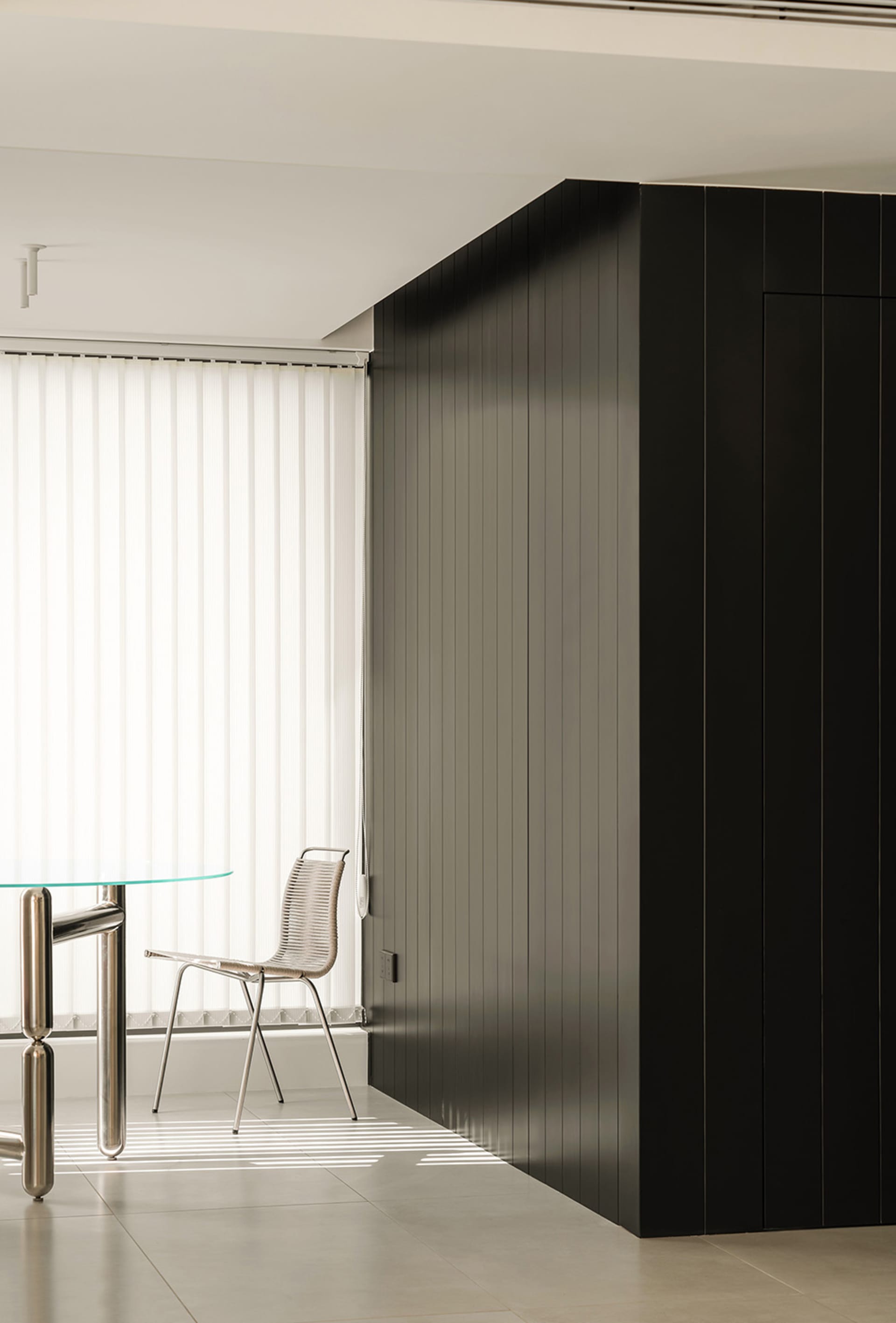 A modern office space featuring black glass paneling walls.