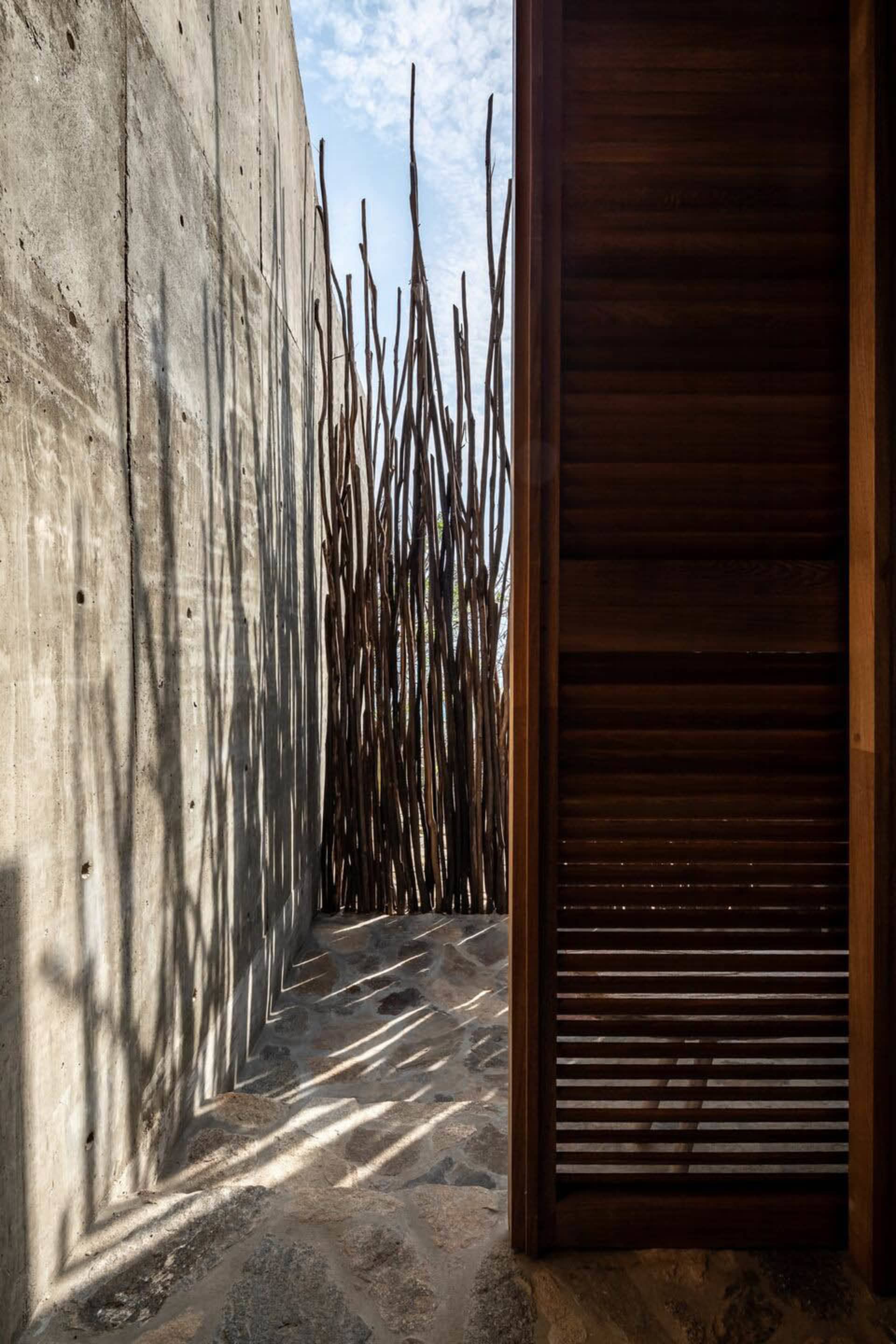 Modern interior design featuring a concrete wall and wooden elements.